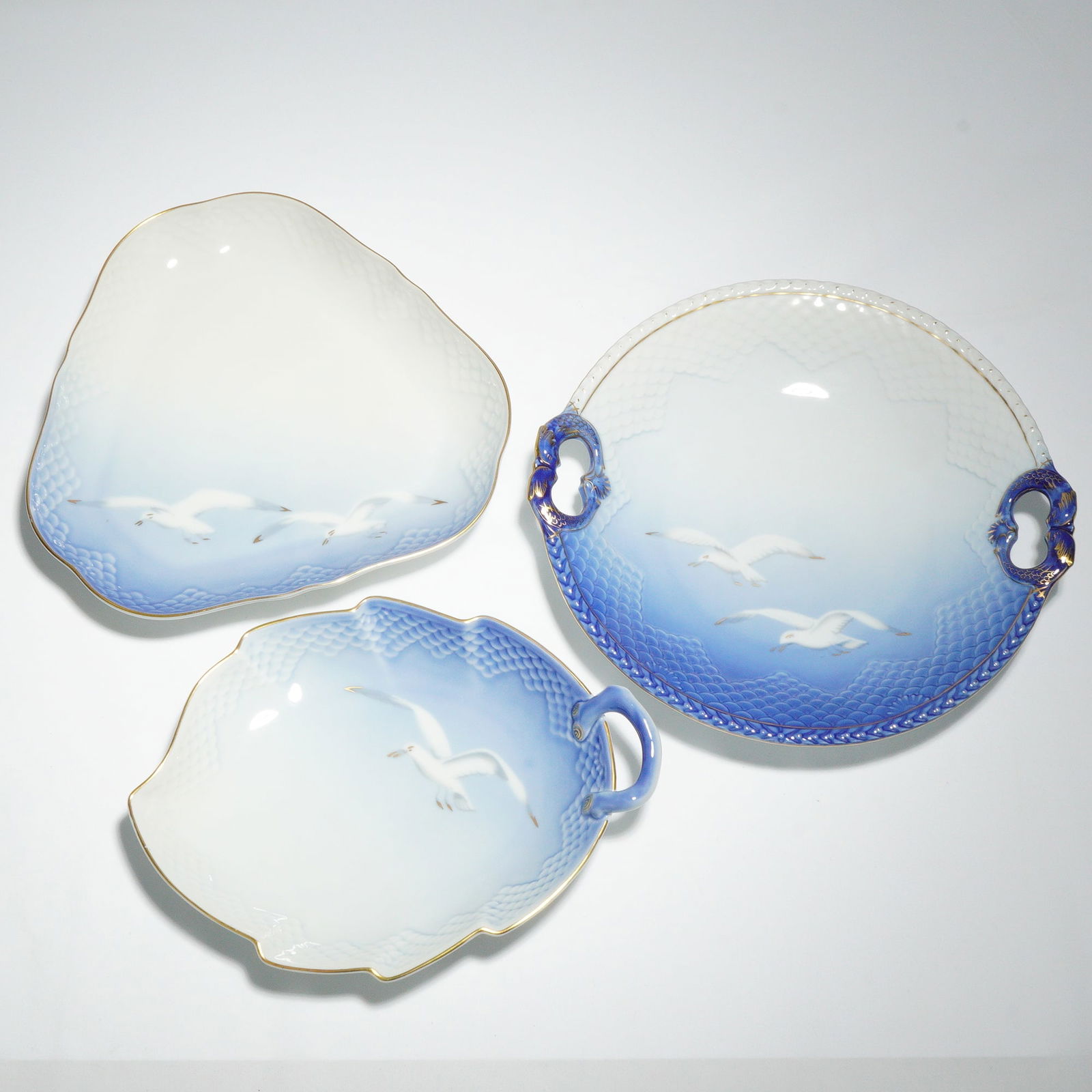 Three Bing & Grondahl Copenhagen Porcelain Seagull Serving Dishes: A group of three Bing & Grondahl Copenhagen Porcelain Seagull serving dishes. Each piece features a graduated underglaze blue fading to white, with hand-painted seagulls in flight against a sky motif.