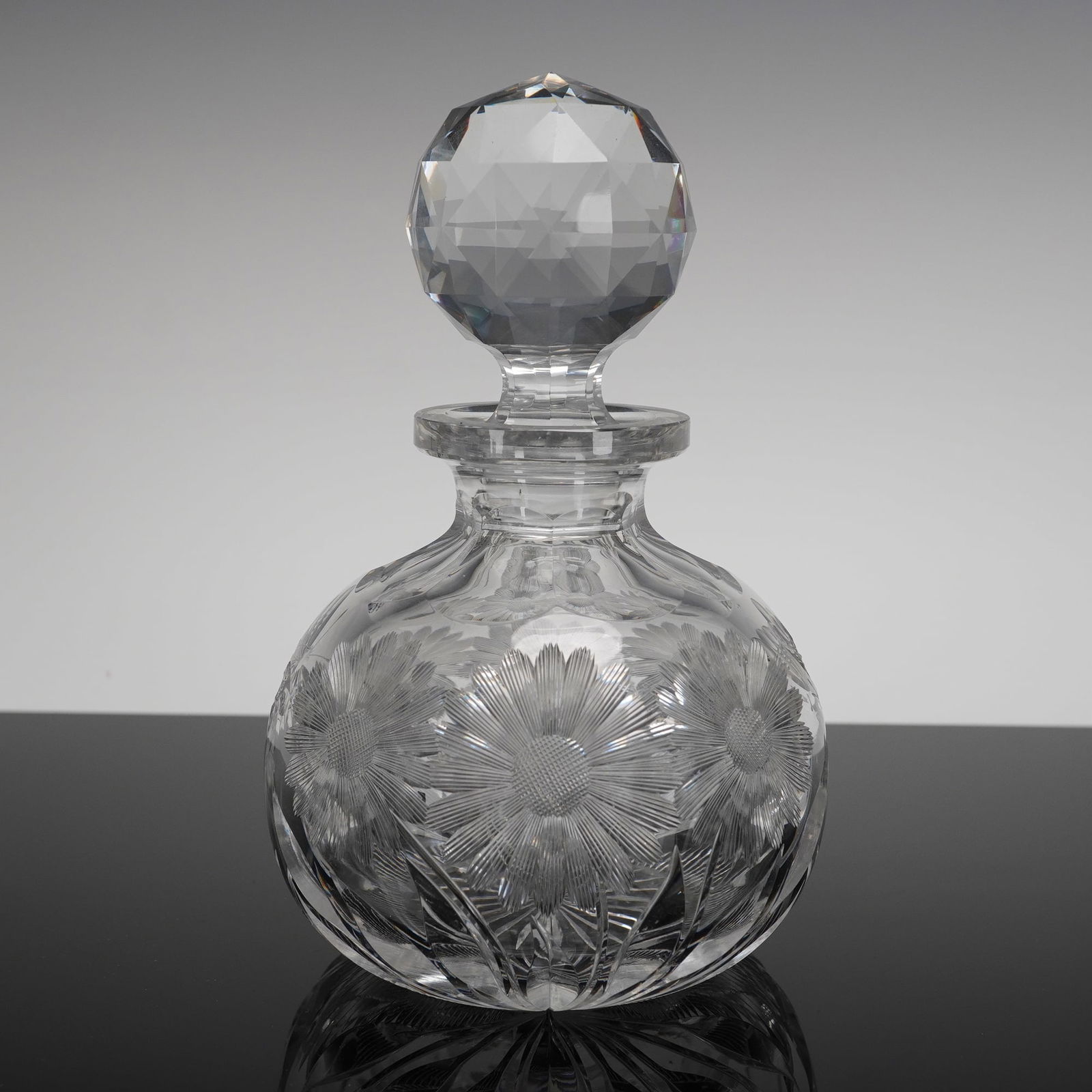 A Cut Crystal Globular Decanter and Stopper, Featuring Floral Motifs (1 of 3)