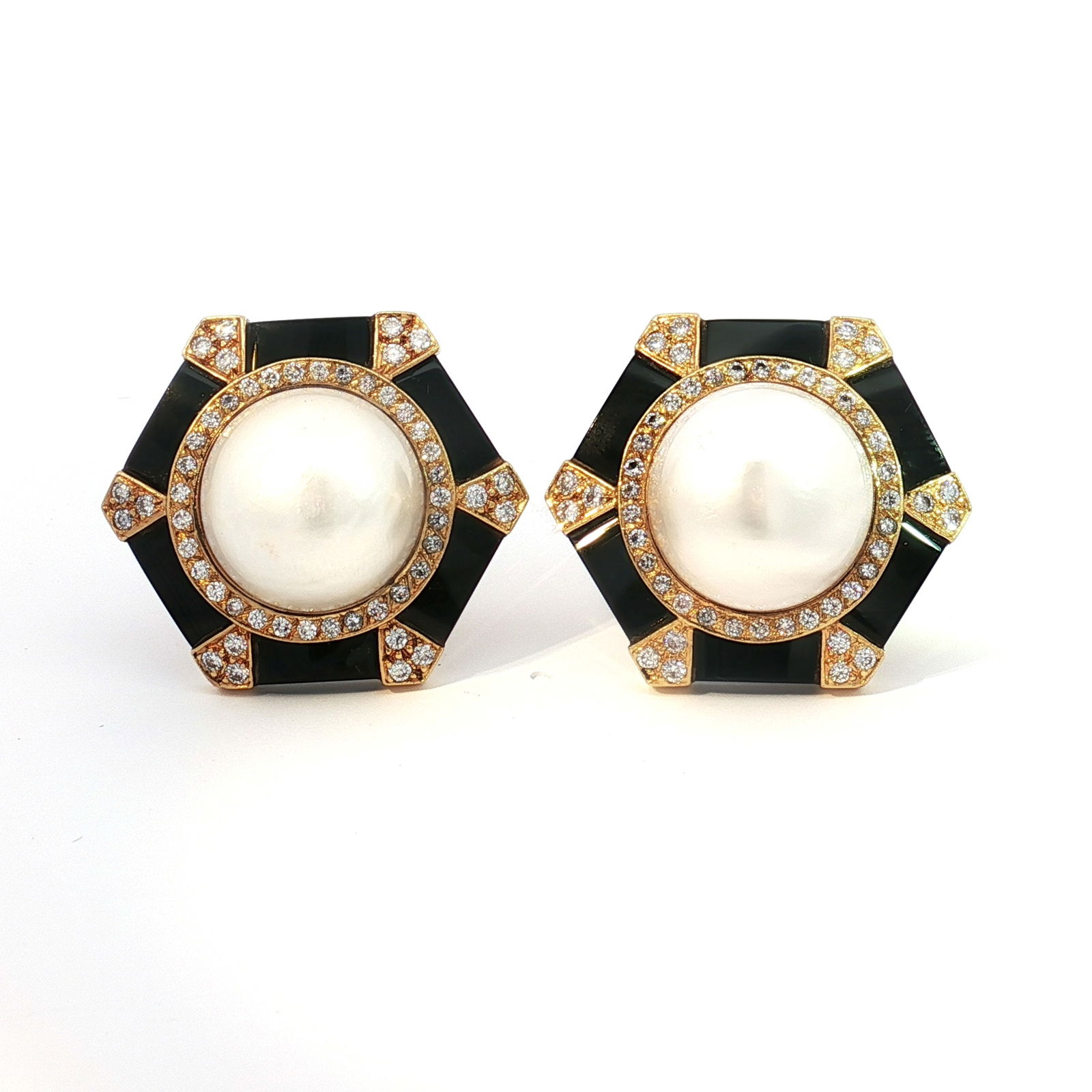 Pair of 18K Gold Mabe Pearl and 1.00ctw Diamond Earrings: These are hexagonal shaped chip earrings, crafted from 18K yellow gold and onyx. Each earring features a large Mabe pearl surrounded by diamonds. The diamonds have a combined total weight of approxima
