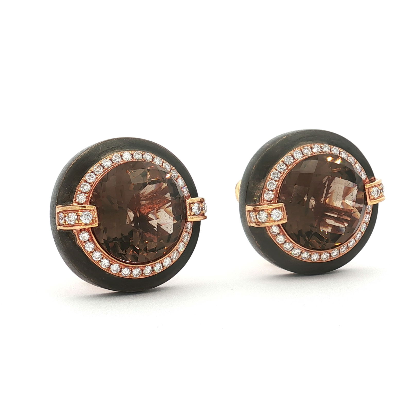 Pair of Estate 18K Rose Gold Smoky Quartz and Diamond Earrings: These 18K rose gold clip earrings feature faceted large smoky quartz gemstones surrounded by a halo of diamonds. The band outside of the diamonds is a metallic dark gray hue. The clip backings are mar
