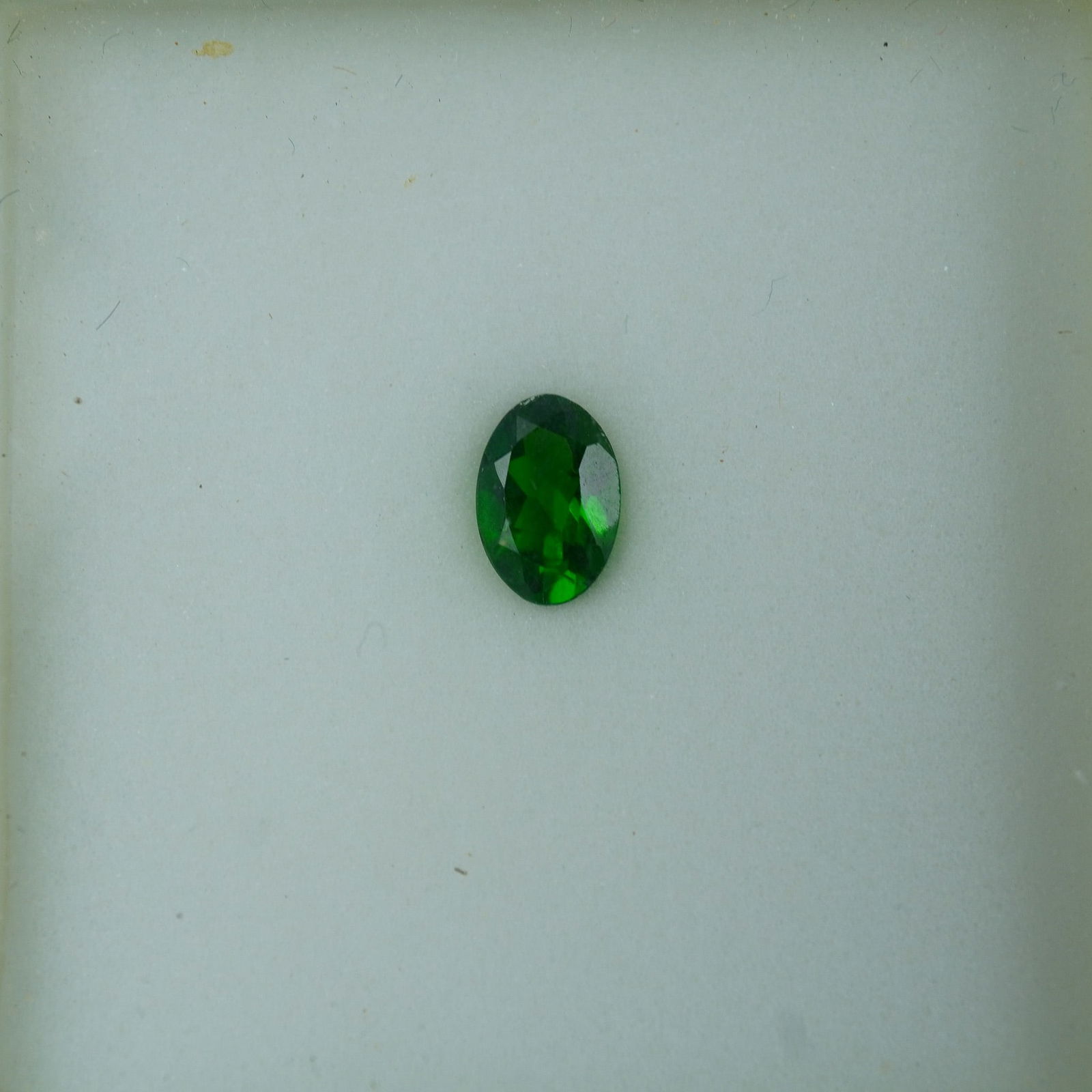 0.40 CT Chrome Diopside Oval Cut Gemstone: Brilliant green chrome diopside gemstone in an oval cut, known for its intense color and excellent transparency. Sourced primarily from Siberia, this gemstone is a popular choice for vibrant, eye-catc