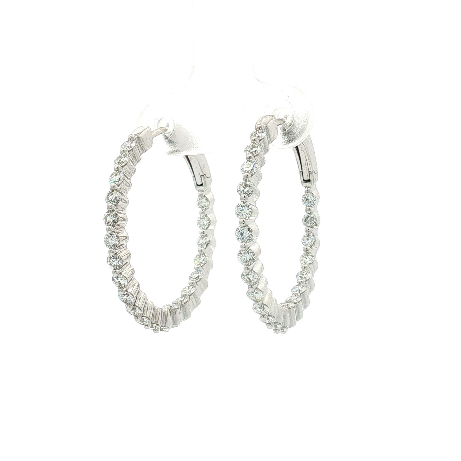Pair of 14K White Gold and 1.43ctw Diamond Inside Out Hoop Earrings: These 14K white gold hoop earrings feature a total of 42 diamonds that have a combined total weight of approximately 1.43 carat. The earrings are designed in an inside out style, with circular-cut dia