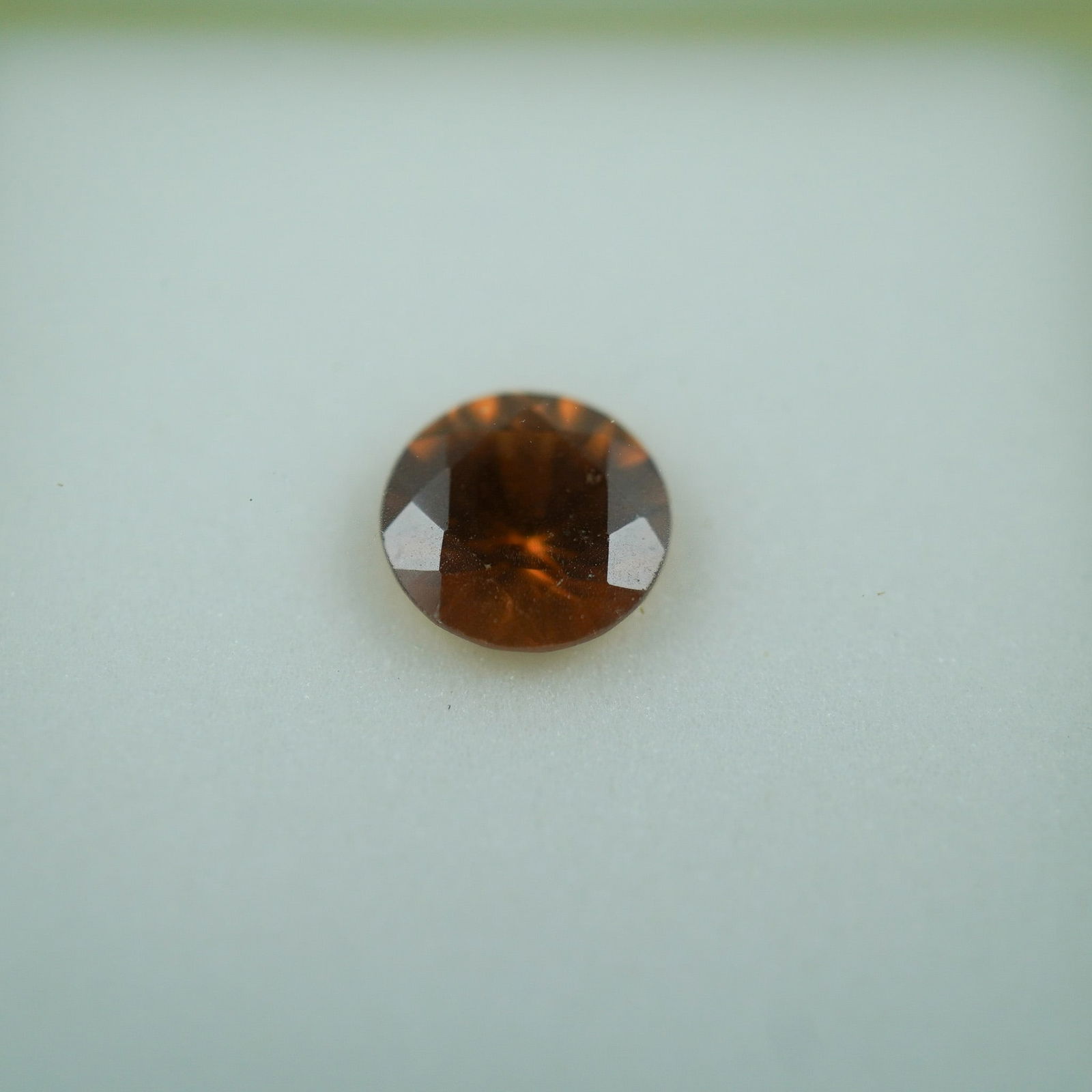 1.25 CT Whiskey Zircon Round Cut Gemstone: This richly colored whiskey zircon exhibits a warm amber-brown hue, complemented by a classic round cut that enhances its brilliance and depth. Weighing approximately 1.25 carats, this gem is ideal fo