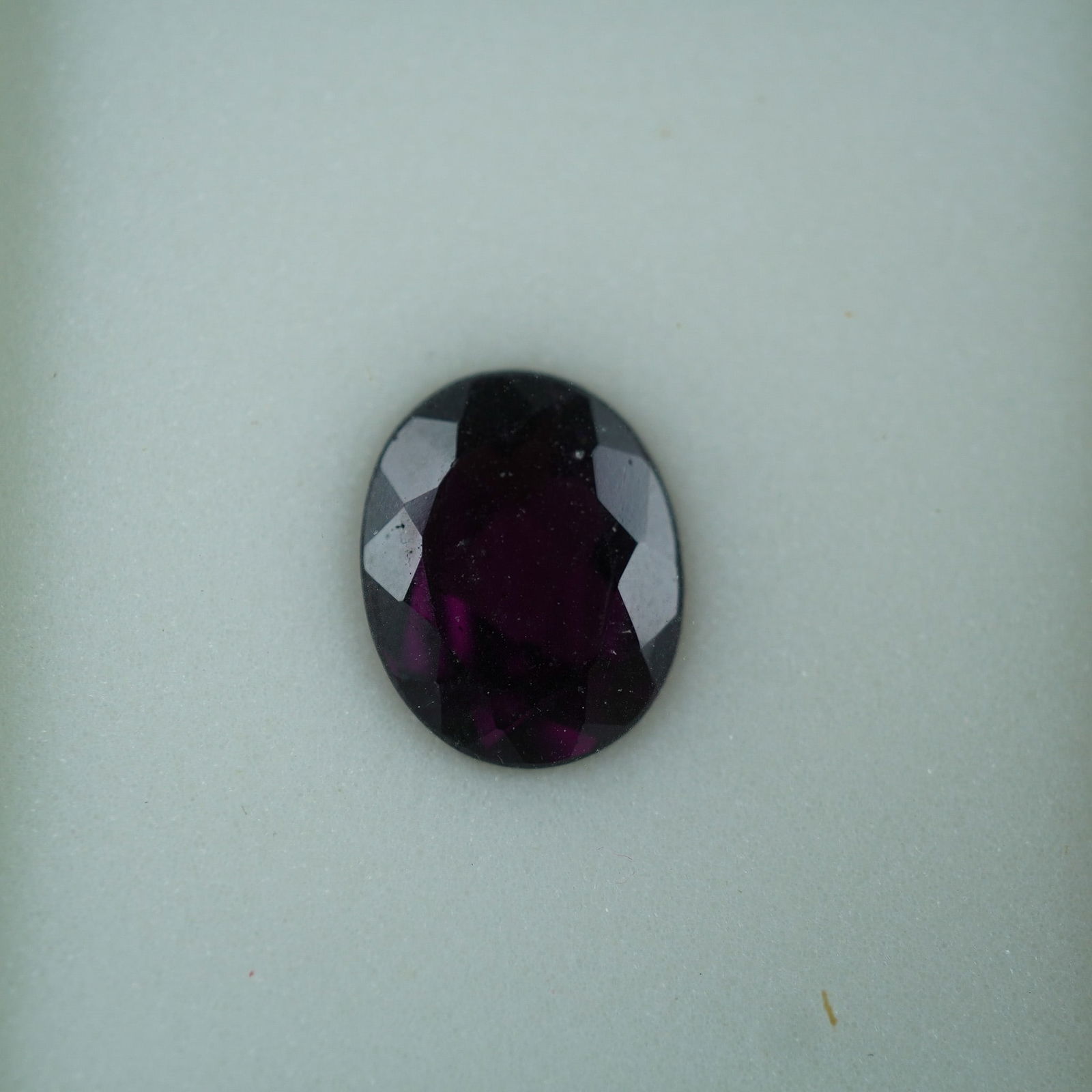 3.25 CT Rhodolite Garnet Oval Cut Gemstone: Rhodolite garnet gemstone weighing approximately 3.25 carats with an oval cut. This stone showcases the brilliant, deep raspberry hue characteristic of rhodolite " a variety formed from a natural blen