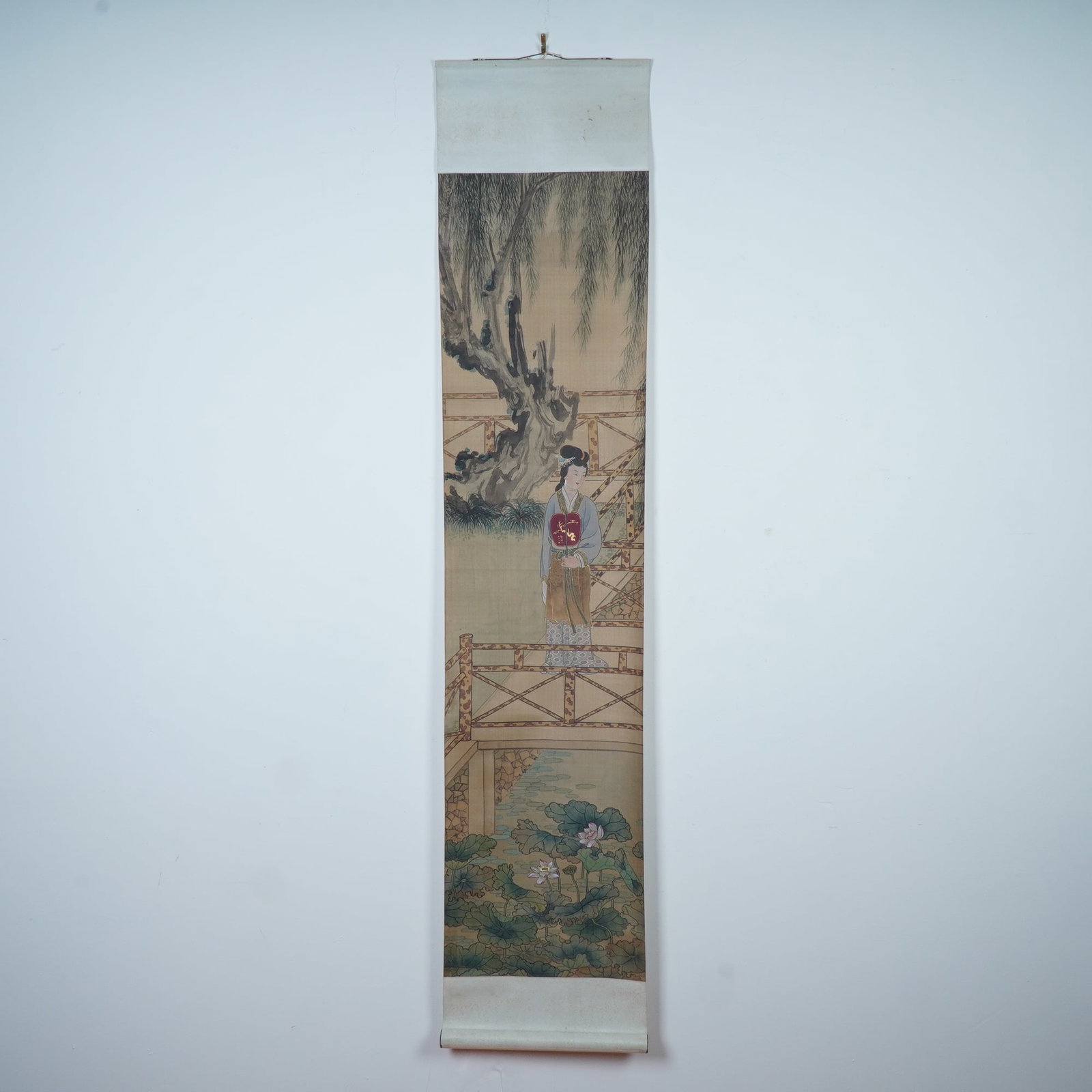 Chinese Ink & Watercolor on Paper Hanging Scroll, Courtly Scene: A finely executed Chinese ink and watercolor painting on paper with a silk-like texture depicting an elegant lady from a courtly scene standing on a rustic garden bridge, framed by an ancient gnarled