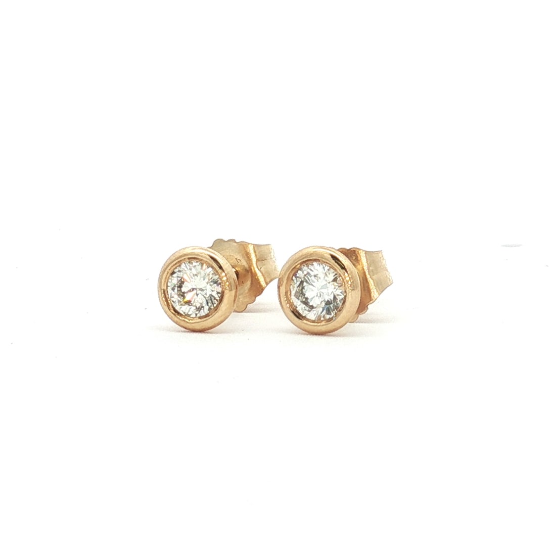 Pair of 14K Gold and 0.30ctw Diamond Martini Stud Earrings: These stud earrings are constructed from round diamonds bezel set in circular 14K yellow gold settings. The diamonds have a combined total weight of approximately 0.30 carat. The posts and butterfly b