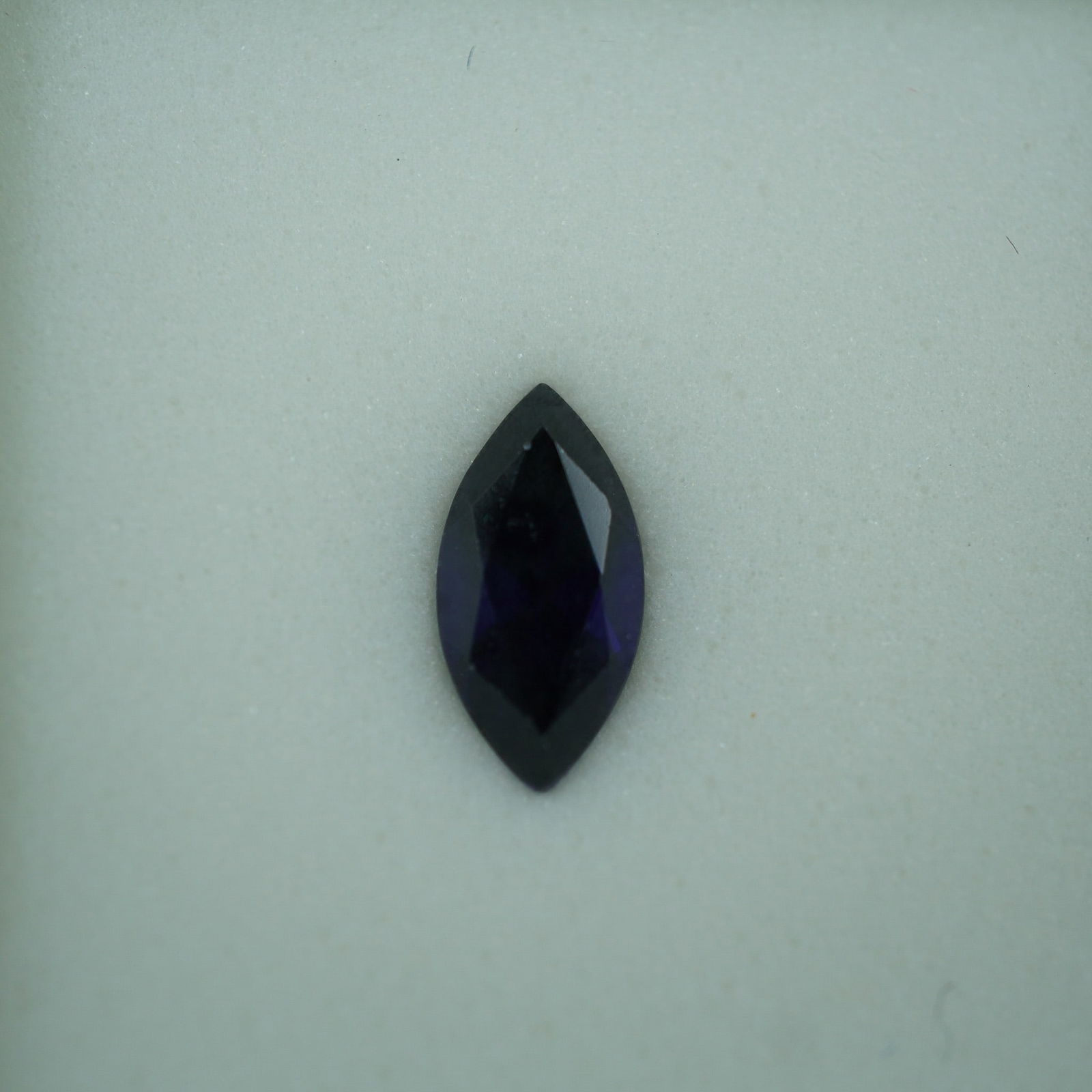 1.30 CT Lab-Created Sapphire Marquise Cut Gemstone: This 1.30 carat lab-created sapphire features a striking marquise cut, showcasing a deep, rich blue hue and exceptional clarity. It captures light beautifully with its vibrant color and elegant