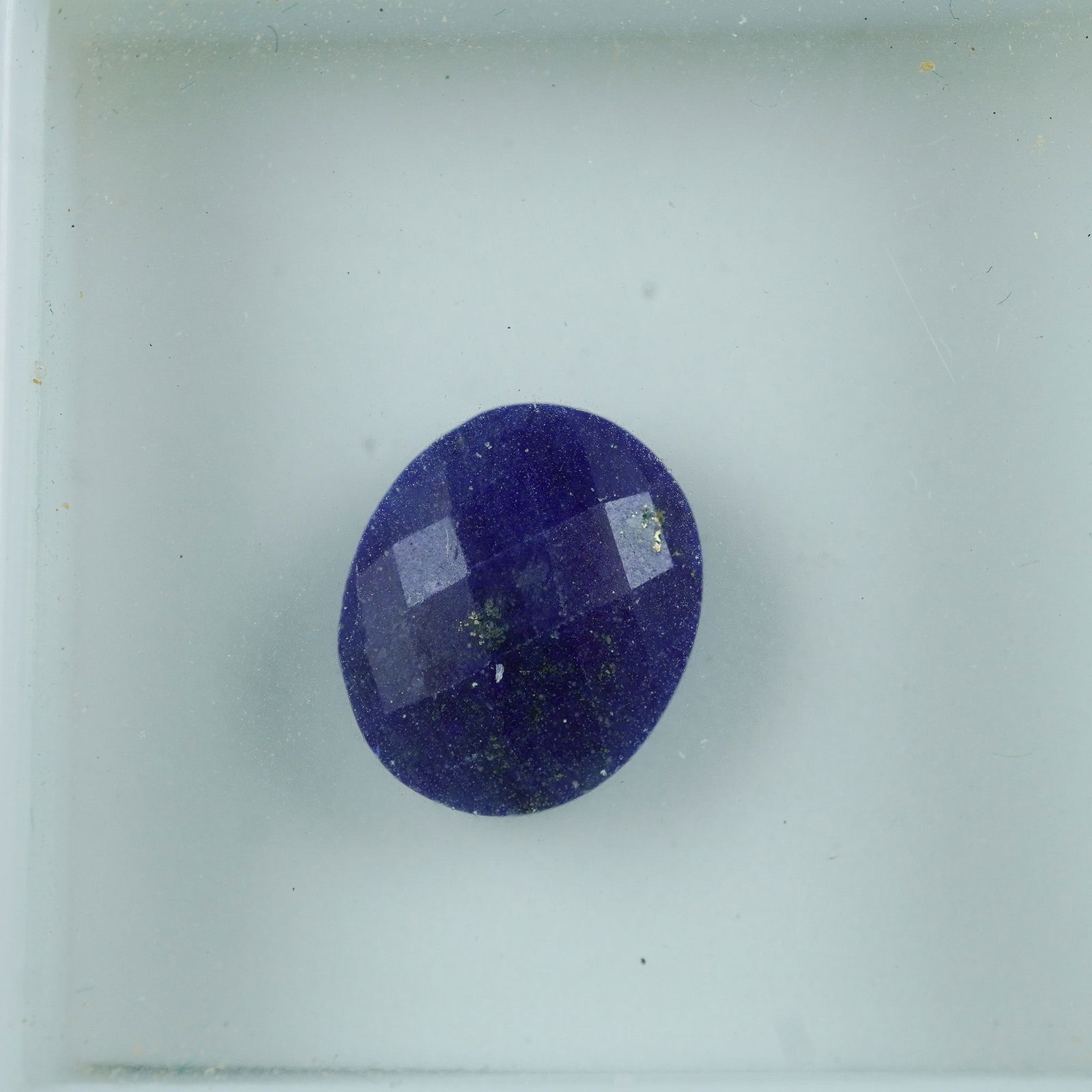 3.70 CT Lapis Oval Cut Gemstone: Deep blue lapis lazuli gemstone in a checkerboard-faceted oval cut, featuring natural golden pyrite flecks throughout. Known for its rich color and ancient use in decorative arts, lapis is ideal for