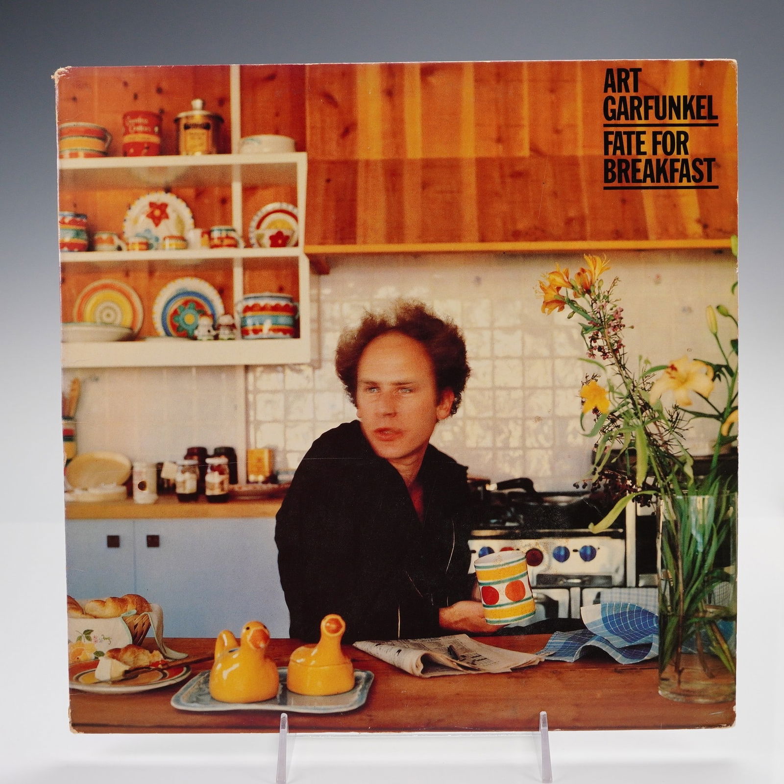 Columbia Records Art Garfunkel Vinyl Record, Fate for Breakfast: This 12-inch vinyl record features Art Garfunkel's 1979 studio album "Fate for Breakfast," released by Columbia Records. The front cover presents a candid kitchen scene with Garfunkel in a domestic se