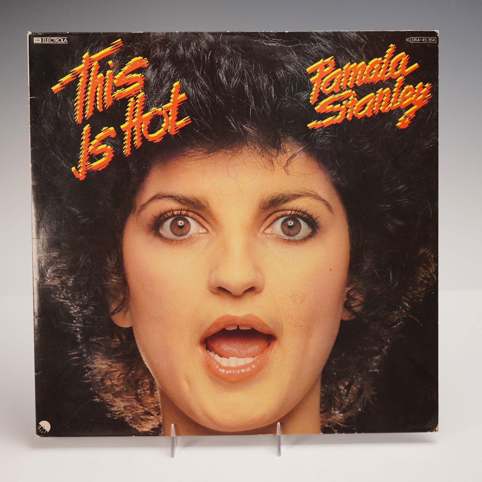 EMI Electrola Pamala Stanley Vinyl Record, This Is Hot: An original German pressing of "This Is Hot," the 1979 full-length album by Pamala Stanley, released by EMI Electrola. The jacket features a striking close-up portrait of the artist on the front and a