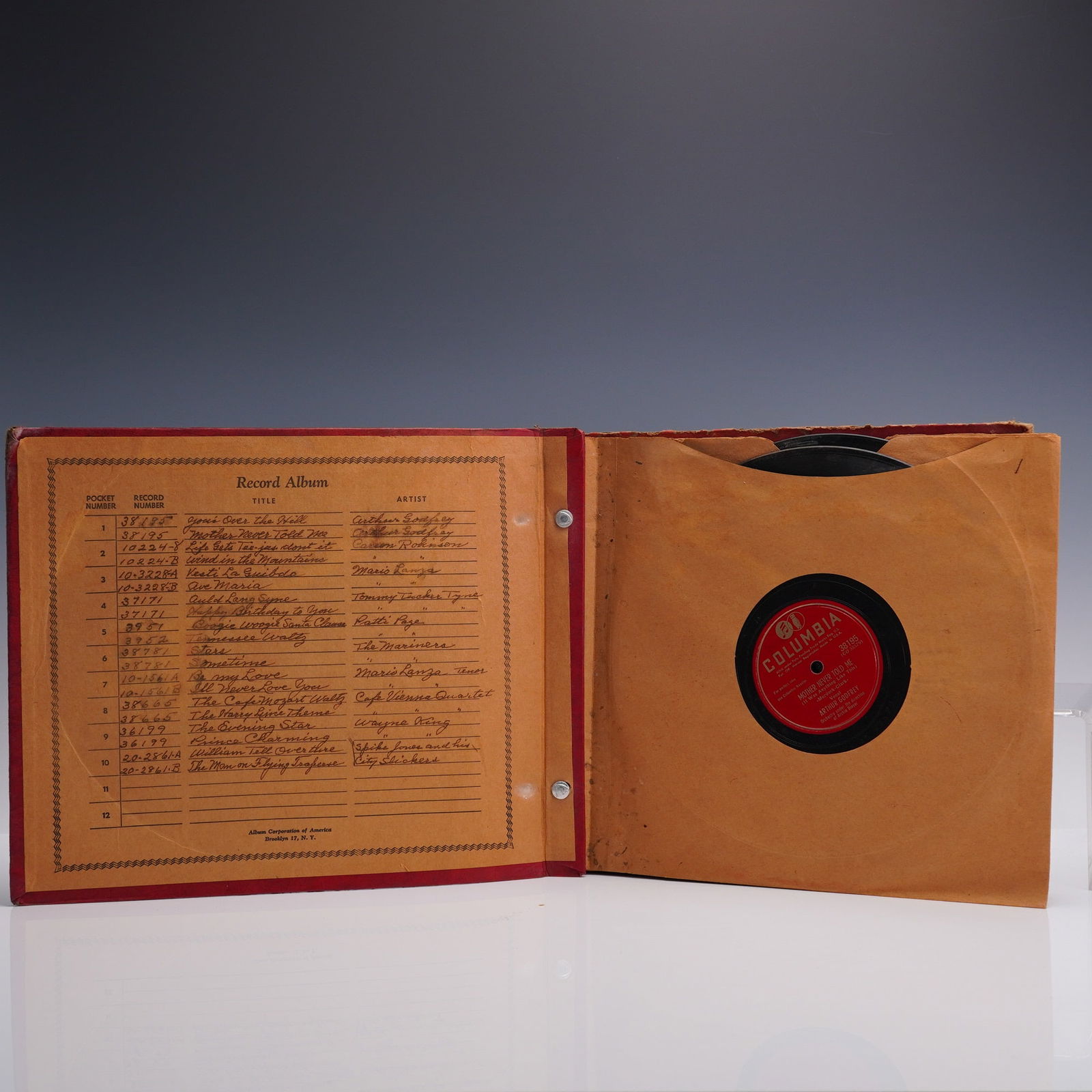 7pc 78 RPM Record Album Book, Columbia & Mercury Labels + Case: Vintage red vinyl-covered record album containing six 78 RPM records from artists including Patti Page, The Mariners, Arthur Godfrey and more. Labels include Columbia and Mercury, with songs such as '