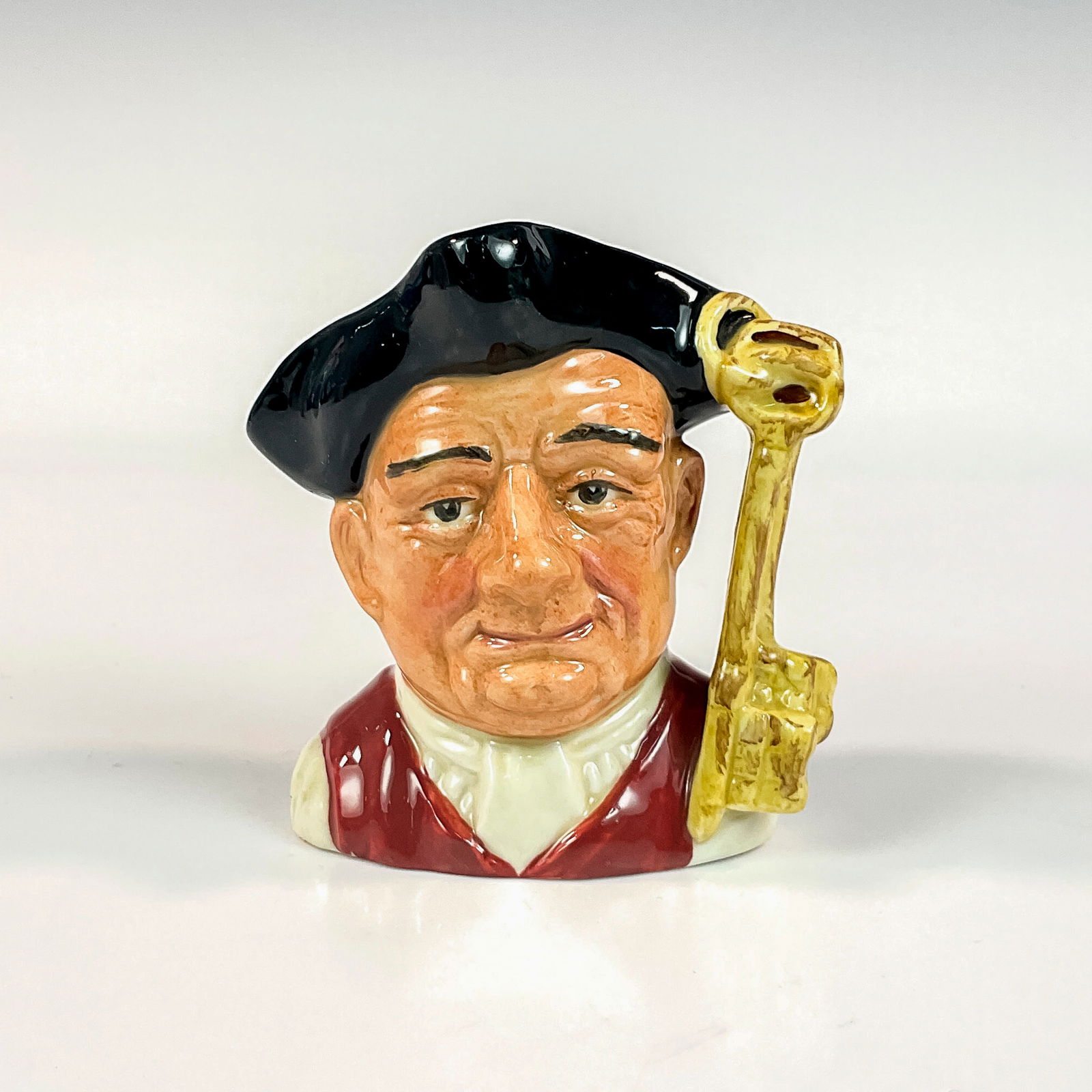 Gaoler D6577 - Small - Royal Doulton Character Jug: Black tricorn; white shirt; red vest. Artist: David B. Biggs Issued: 1963-1983 Dimensions: 3.75-H Country of Origin: England