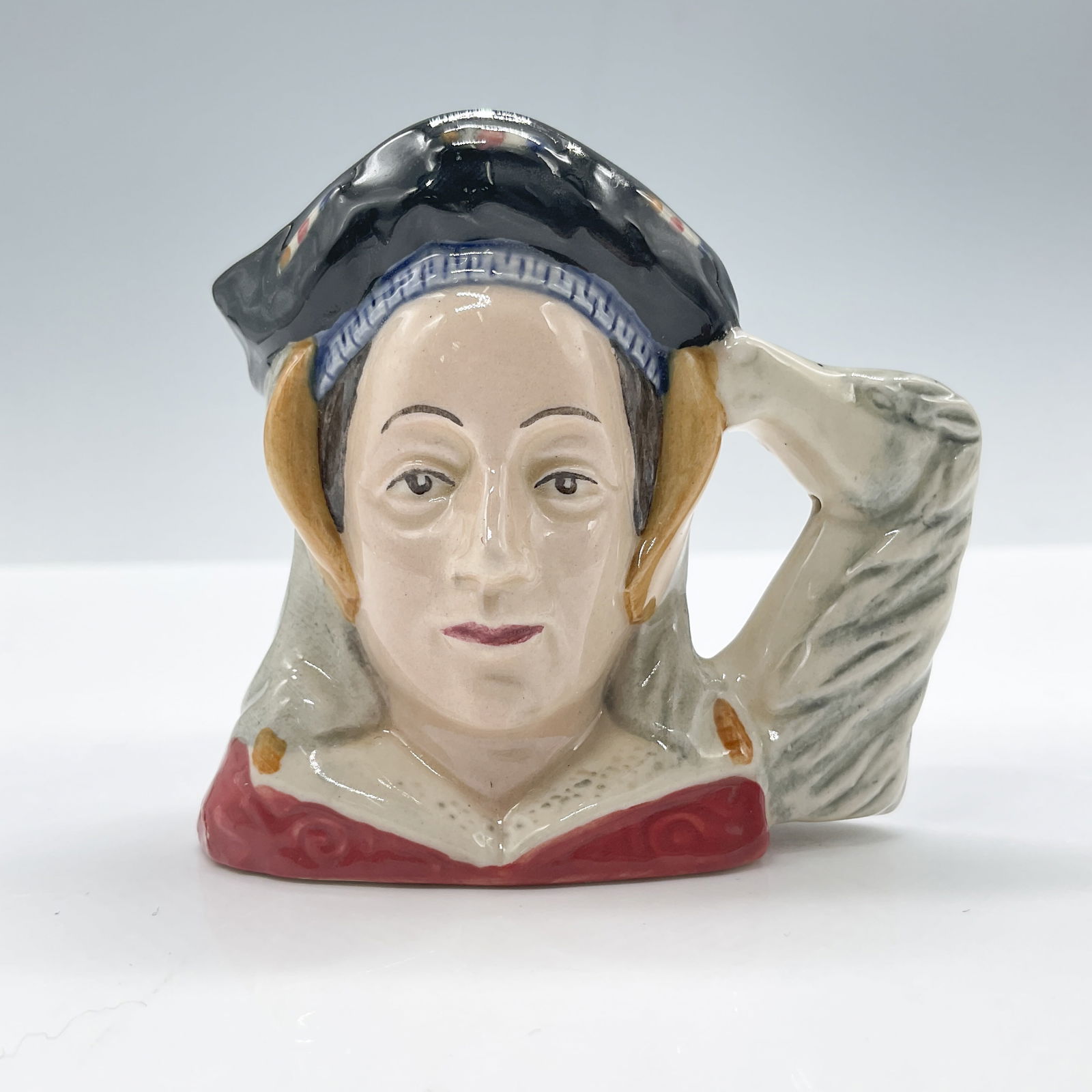 Anne of Cleves D6754 - Mini - Royal Doulton Character Jug: Royal Doulton backstamp. Artist: Peter Gee Issued: 1987 - 1990 Dimensions: 2.5"H Country of Origin: England