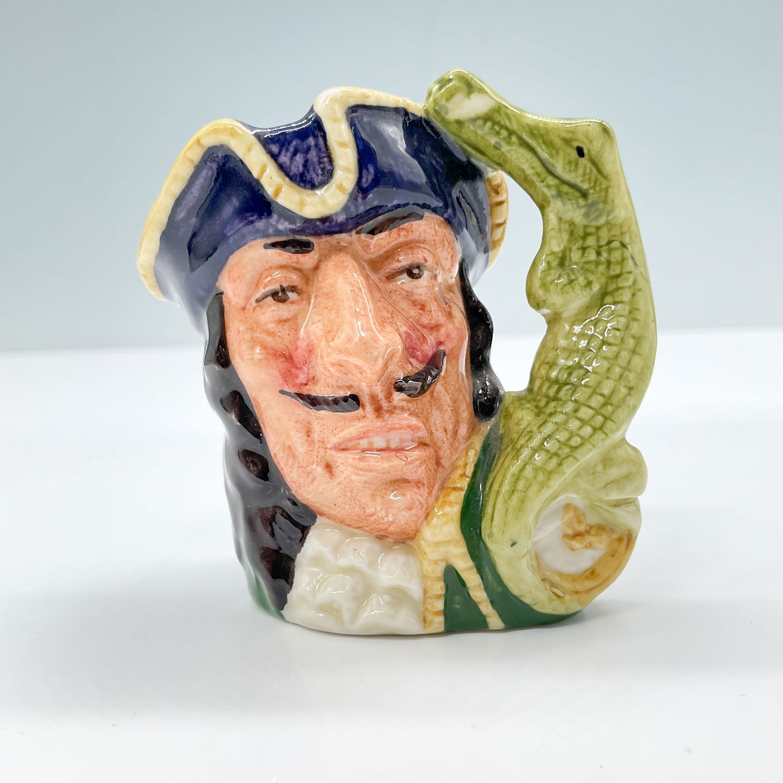 Capt Hook D6605 - Mini - Royal Doulton Character Jug: Royal Doulton backstamp. Artist: Max Henk and David B. Biggs Issued: 1965 - 1971 Dimensions: 2.5"H Country of Origin: England