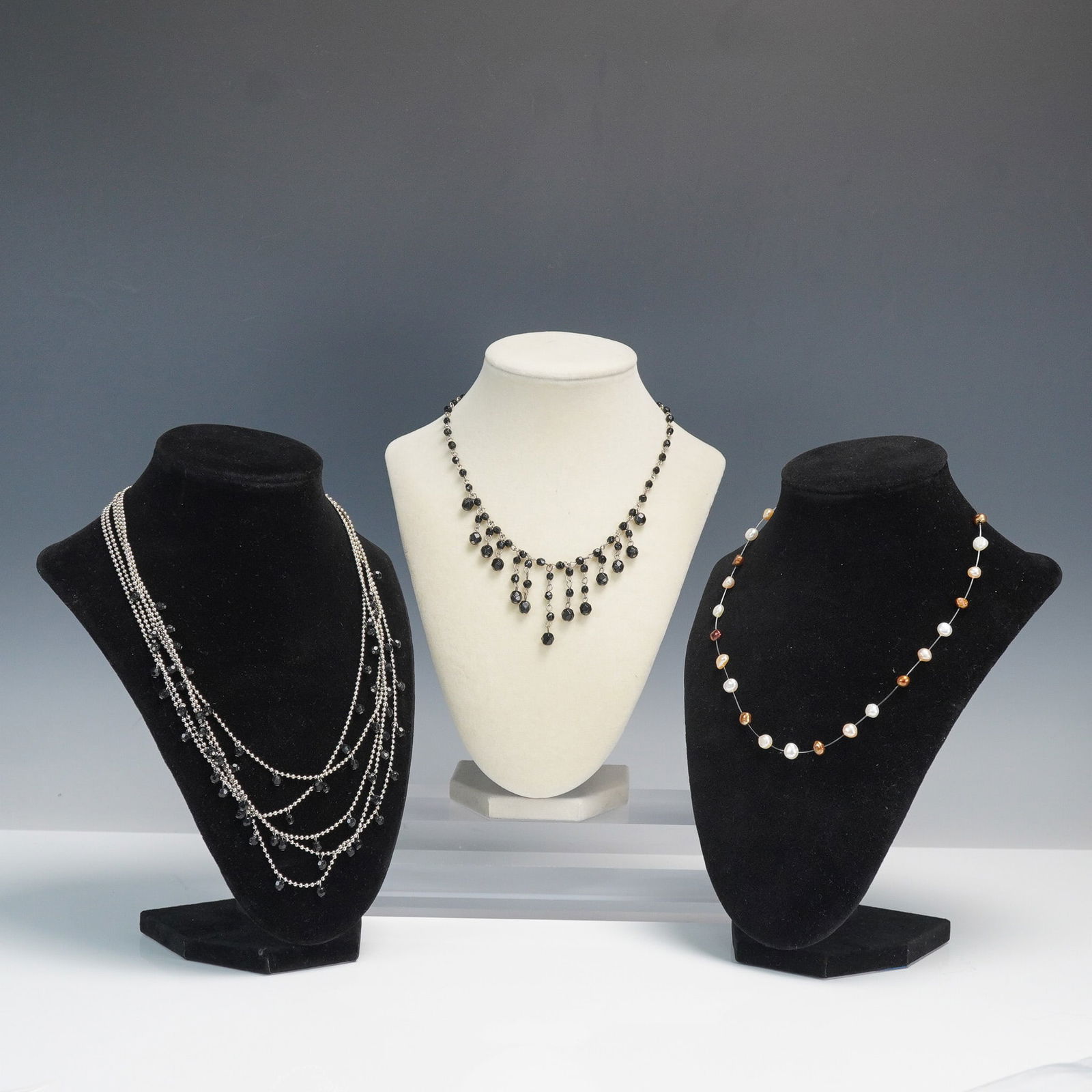 3pc Mixed Material Beaded Necklaces: Collection includes three necklaces featuring various materials and designs. The first necklace features graduated black faceted beads arranged in a cascading tiered fringe design, suspended from a si
