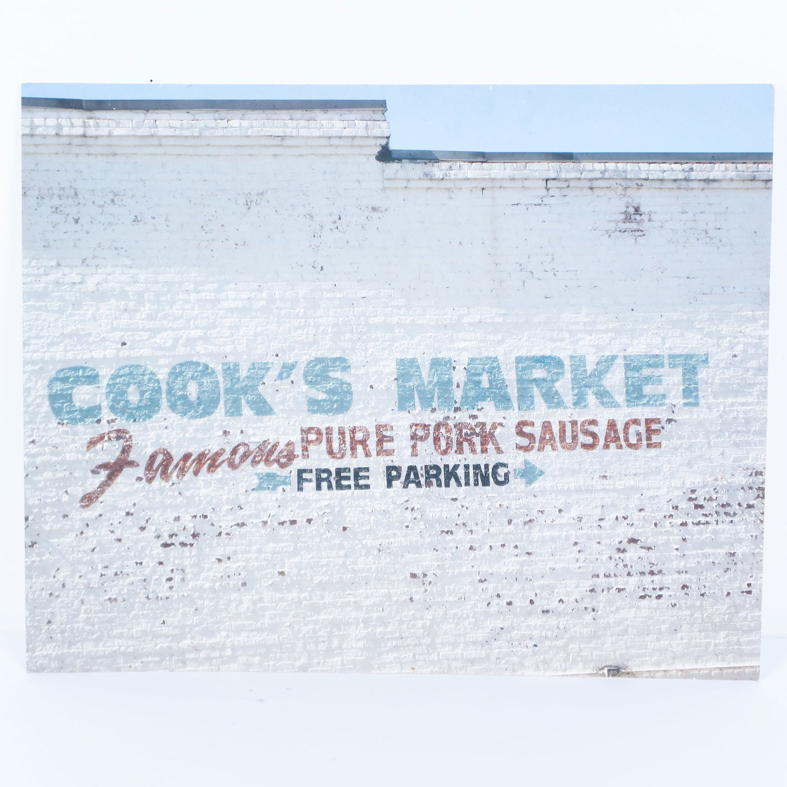Contemporary Color Photograph on Board: Cooks Market Georgia: Contemporary original color photograph applied to board featuring a close-up shot of the advertisement for the makers of pork sausage painted on the wall of the Cook's Market in Thomaston Georgia. Art