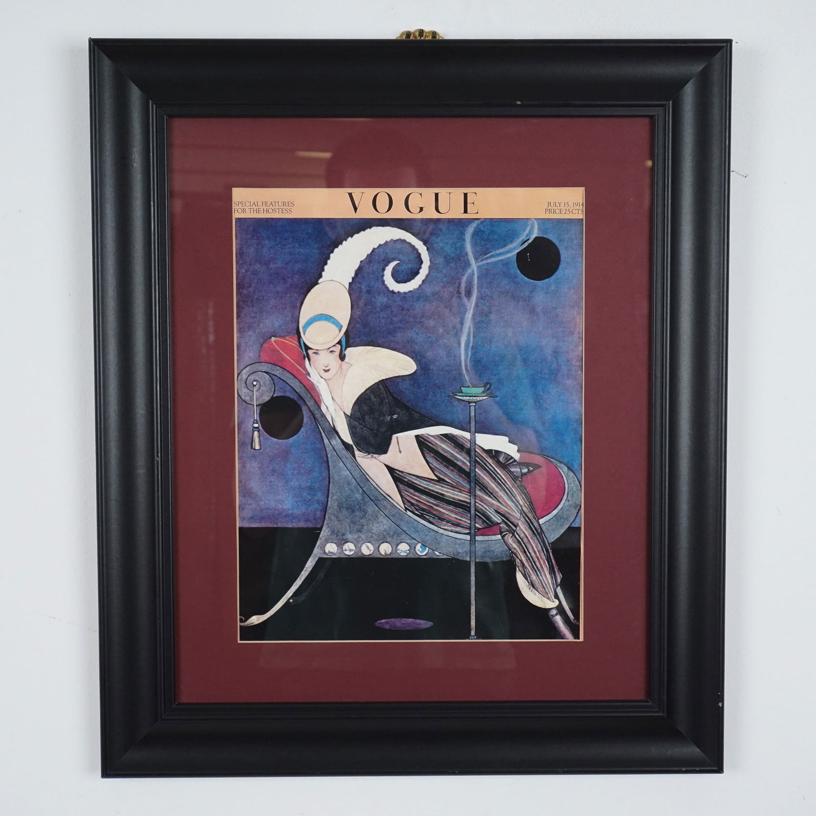 Art Deco Vogue Cover Art Print, Framed: A striking framed reproduction of the iconic Vogue magazine cover from July 15, 1914. This stunning paper cover in a black frame captures the height of Art Deco elegance, showcasing a whimsical yet so