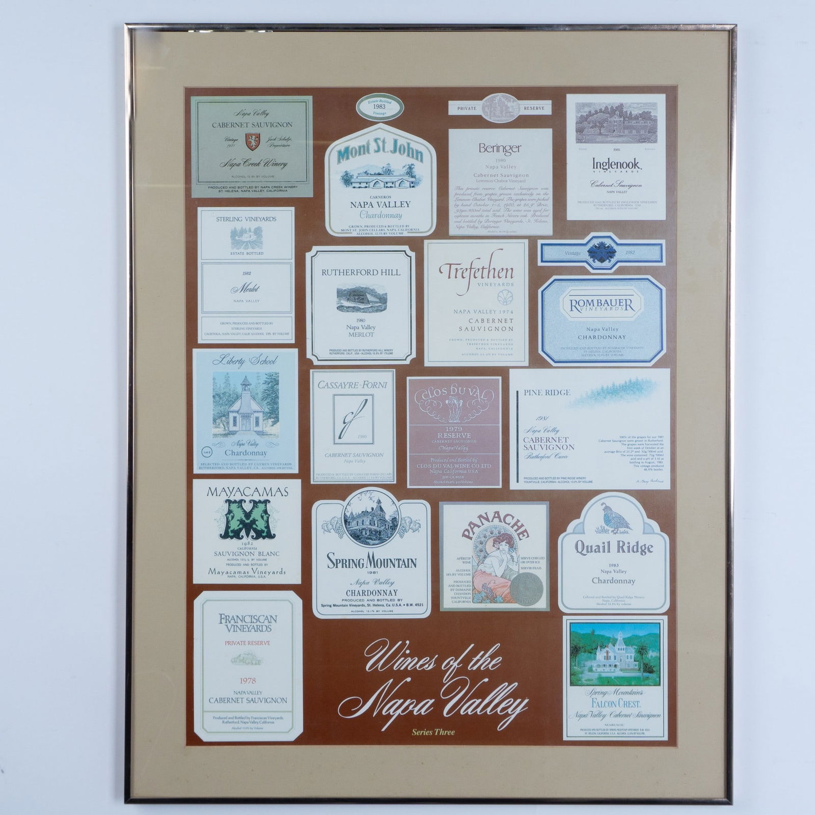 Wines of the Napa Valley Series Three Labels Framed Poster: A lovely framed poster exhibiting 18 vintage Napa Valley wine labels. Housed in a rose gold-colored frame with a beige mat. Poster sight size: 18.75"L x 25"H. Frame dimensions: 24"L x 0.75"W x 30.25"H