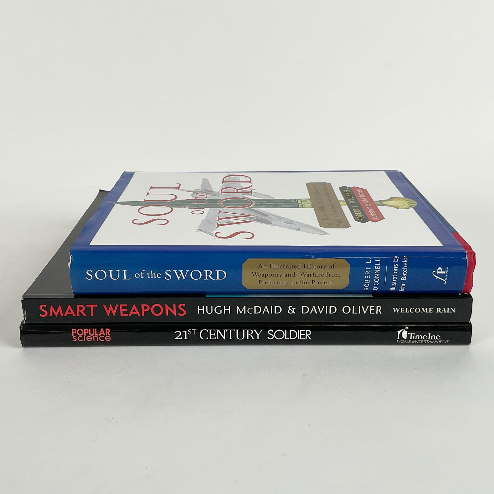 3pc Military and Weaponry History Book Collection: A collection of three books exploring military history, weaponry, and advanced warfare technology. Includes "Soul of the Sword" by Robert L. O'Connell, a hardcover book detailing the evolution of weap