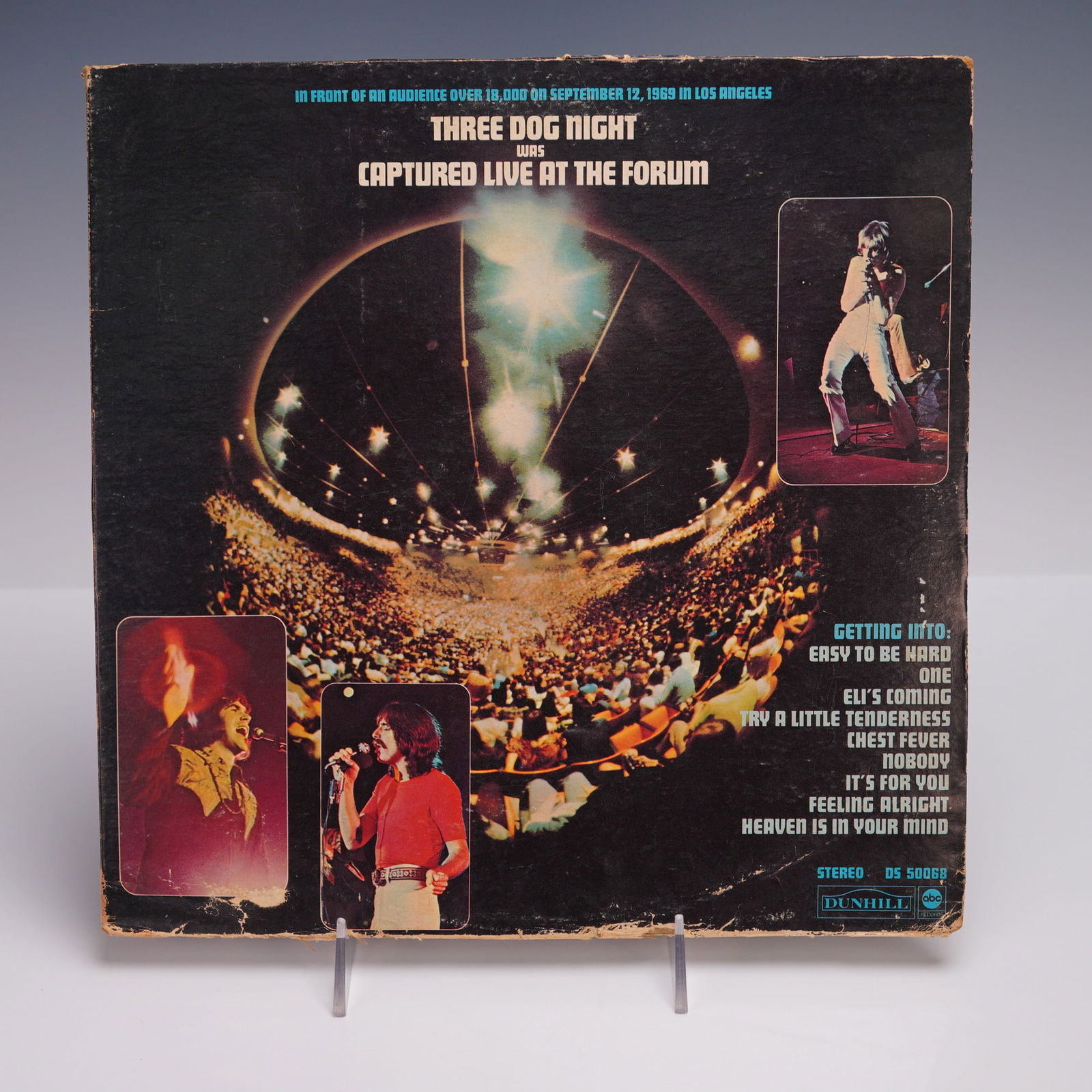 Dunhill Records Three Night Dog Vinyl Record, Captured Live At The Formothe: Original 1969 live album from Three Dog Night, released on Dunhill Records and recorded in concert at The Forum in Los Angeles before an audience of over 18,000. This stereo vinyl LP, catalog number D