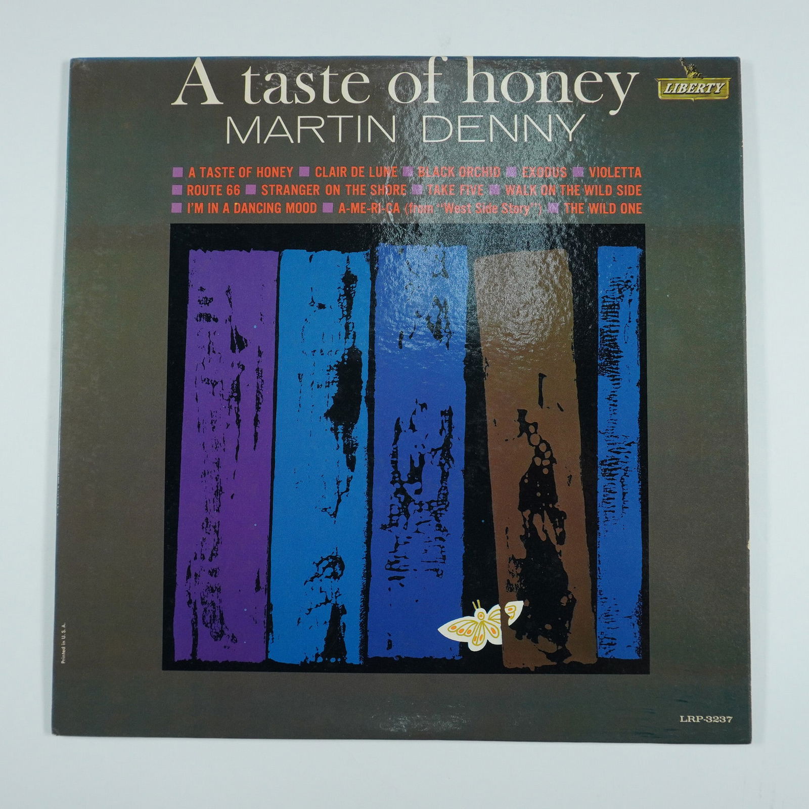 Martin Denny A Taste of Honey Vinyl LP Liberty Records: Martin Denny's A Taste of Honey, released in 1962 by Liberty Records in the USA, showcases the legendary exotica musician's fusion of lounge, jazz, and world influences. The album features vibrant arr