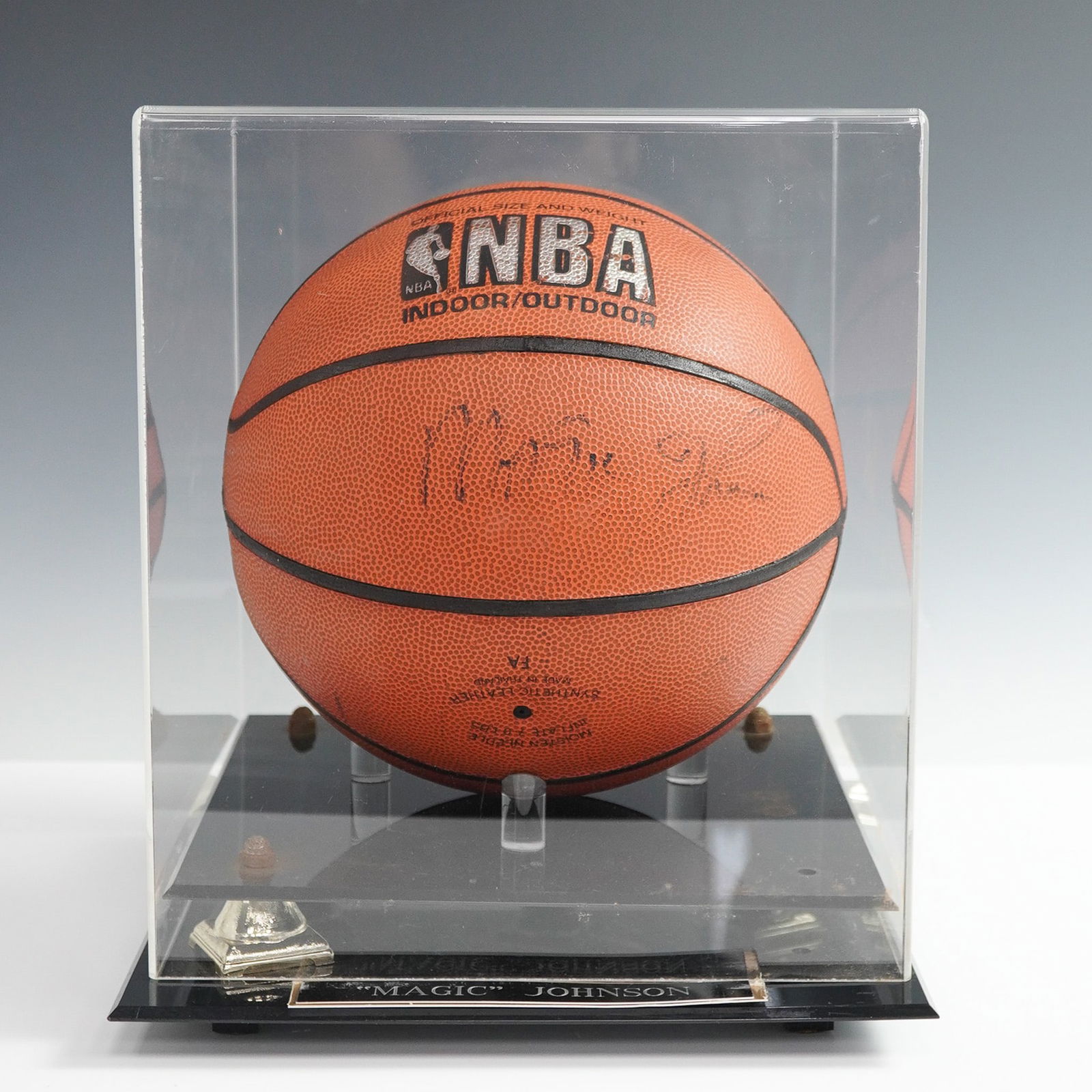Magic Johnson Autographed NBA Basketball with Display Case: This NBA indoor/outdoor basketball bears the signature of basketball legend Earvin Magic Johnson, one of the most celebrated players in NBA history. The ball is housed in a custom display case with a