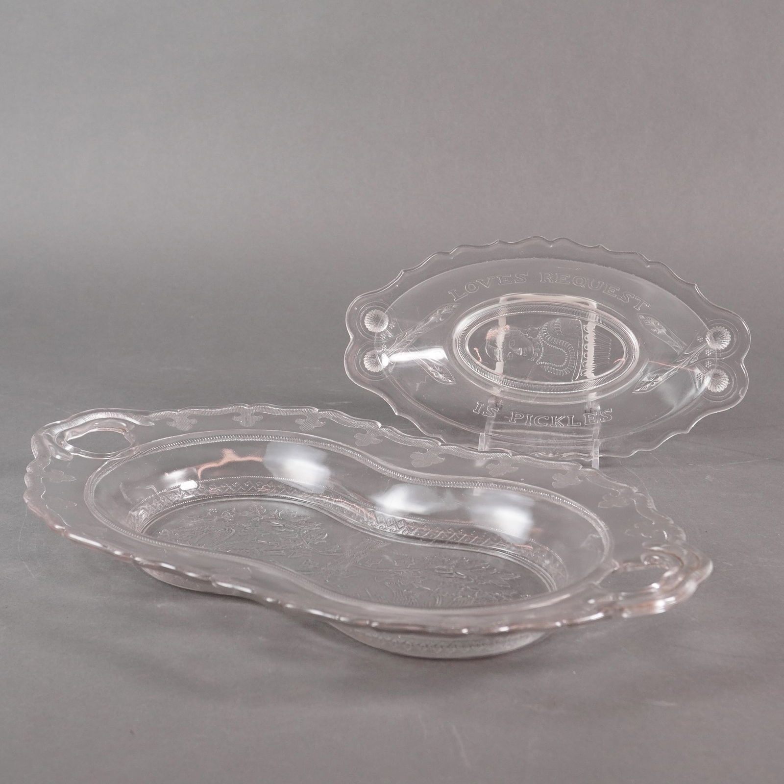 A Pair of EAPG Pressed Glass Serving Dishes, Late 19th Century: A pair of Early American Pattern Glass (EAPG) serving dishes, circa late 19th century. This 2pc EAPG Serving Dishes lot includes a large double-relish or celery dish and a smaller oval relish dish. Bo