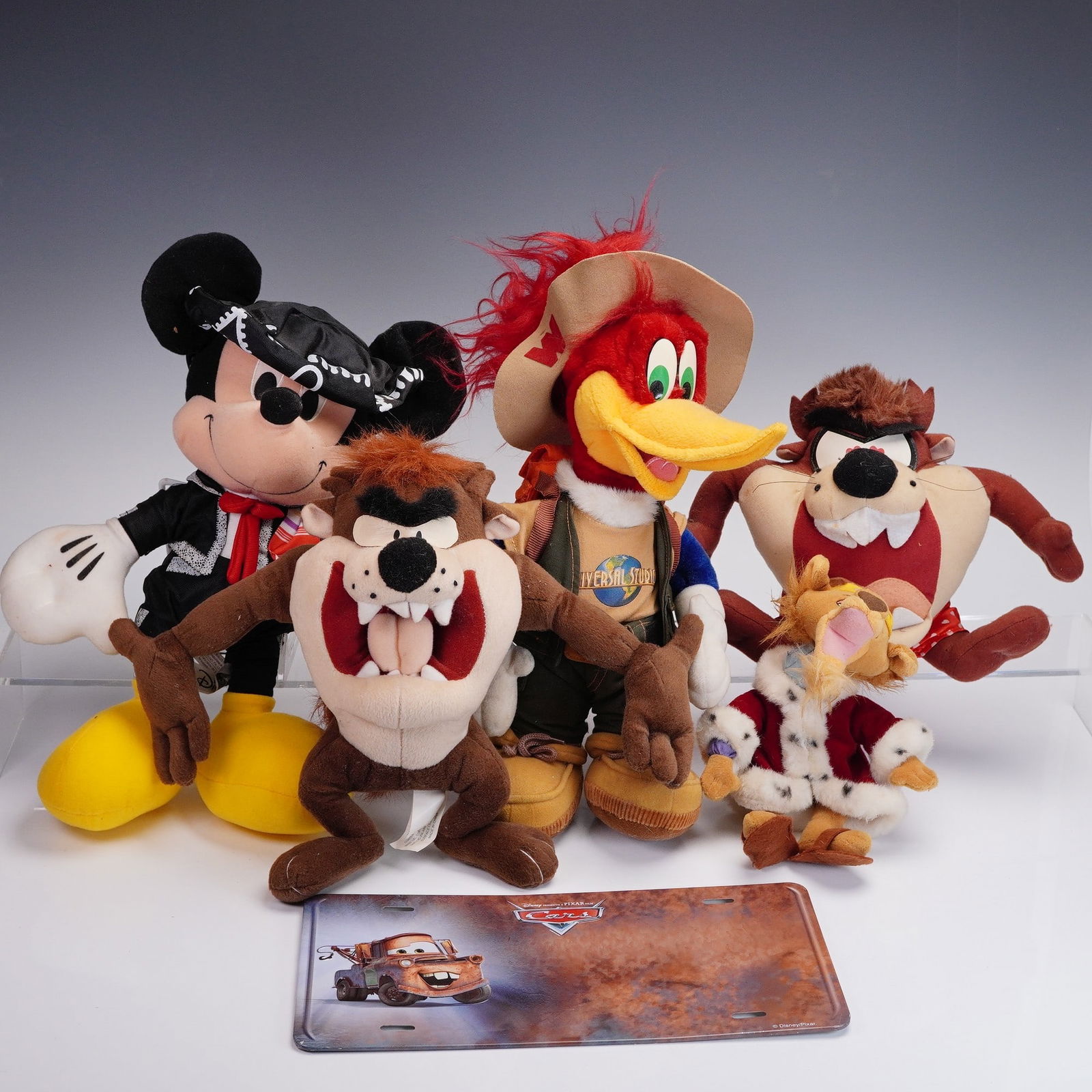 6pc Cartoon Character Plush & Pixar Cars Plate: Group of six cartoon character items, including plush dolls and a novelty license plate. Features a mix of classic and theme park characters, including Taz the Tasmanian Devil, Mickey Mouse in mariach