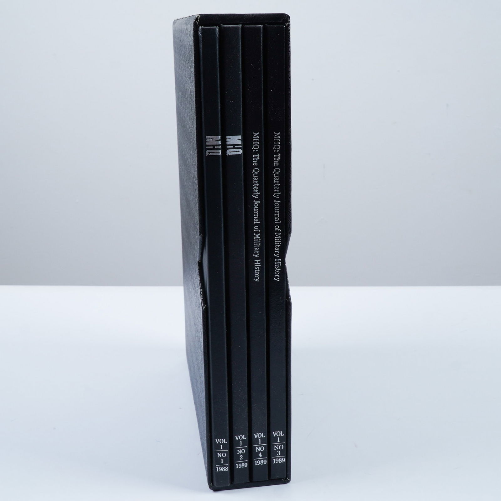4pc Hardcover Books, MHQ: The Quarterly Journal of Military History: This set includes four bound volumes of MHQ: The Quarterly Journal of Military History, covering issues from 1989. These hardcover editions, bound in black covers with silver lettering, feature in-dep