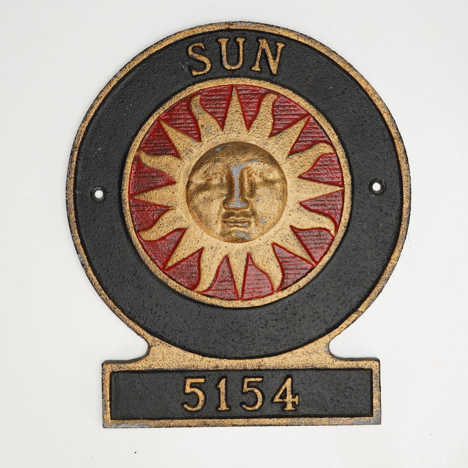 Sun Insurance of London Cast Iron Address Plaque: Decorative cast iron address sign featuring a raised gold and red sunburst motif centered within a circular border. The piece is finished in black with gold-accented lettering and trim, and includes t