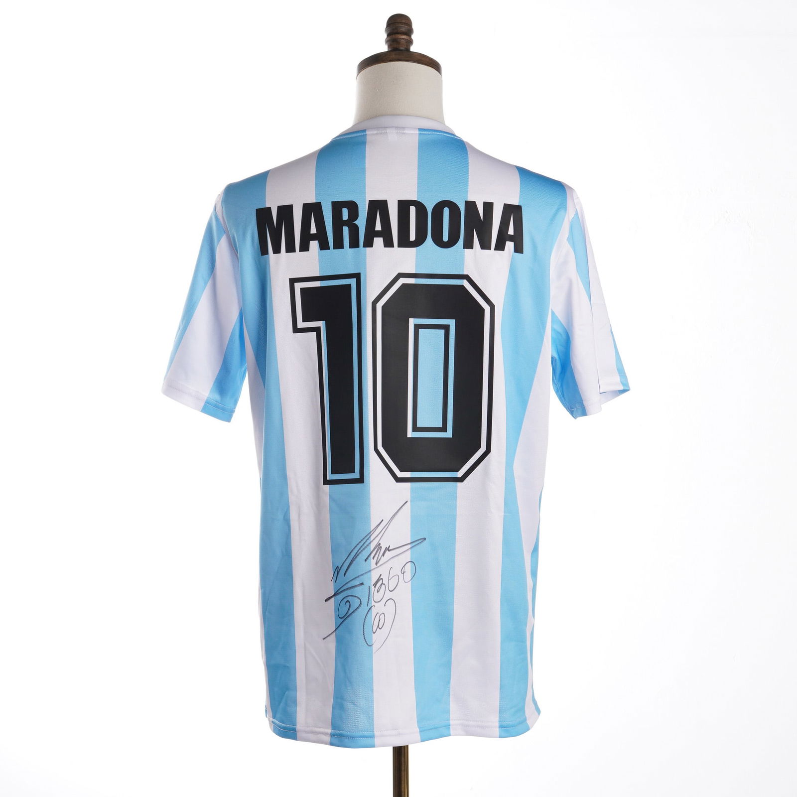 Diego Maradona Signed 1986 Argentina National Team Jersey w/ COA: An autographed Argentina National Team replica home soccer jersey based on the 1986 model year. The garment features light blue and white vertical stripes with the Argentine Football Association (AFA)