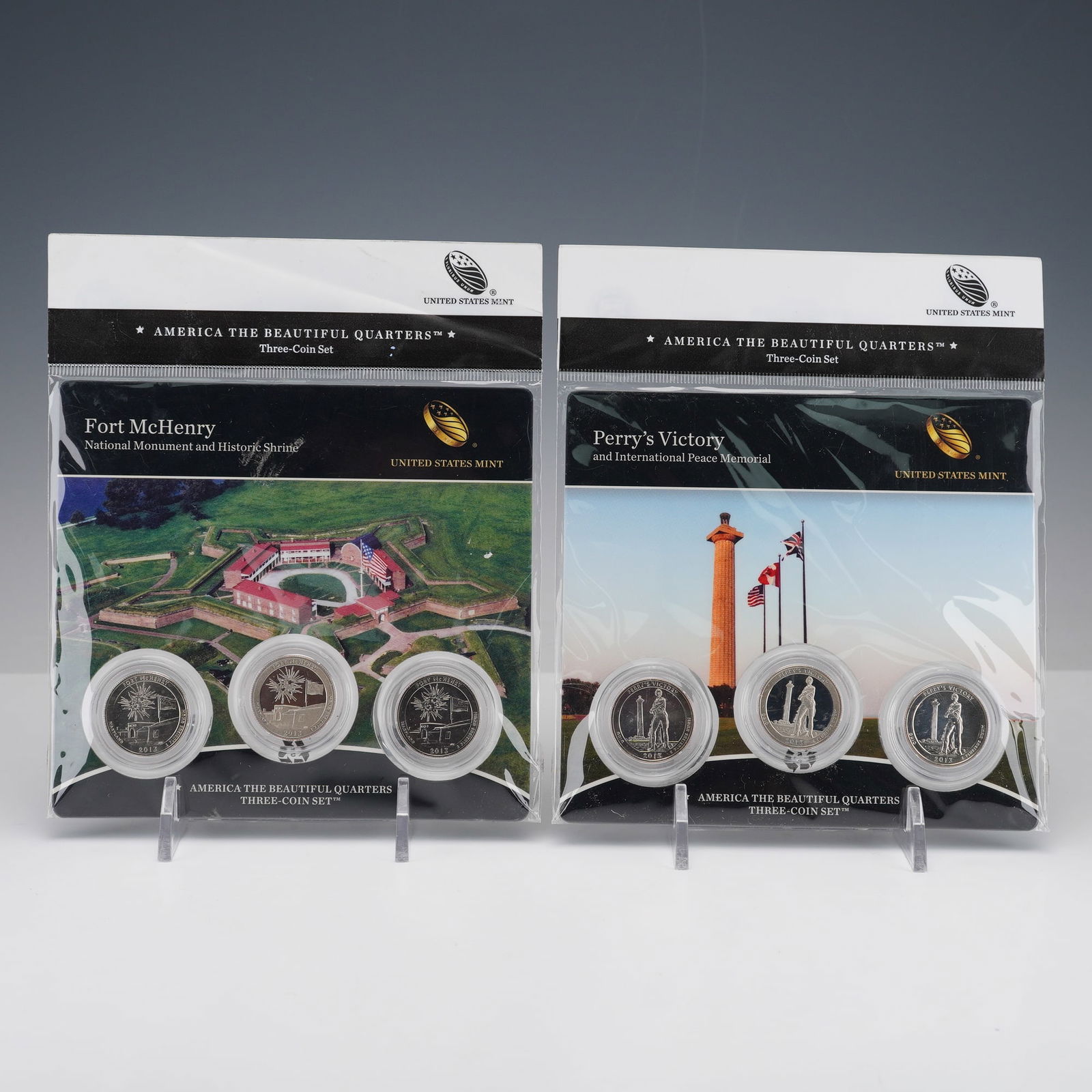 2pc 2013 America the Beautiful Three-Coin Quarters Sets: America the Beautiful Quarters three-coin sets from 2013, including Fort McHenry National Monument and Historic Shrine and Perry's Victory and International Peace Memorial. Each set contains an
