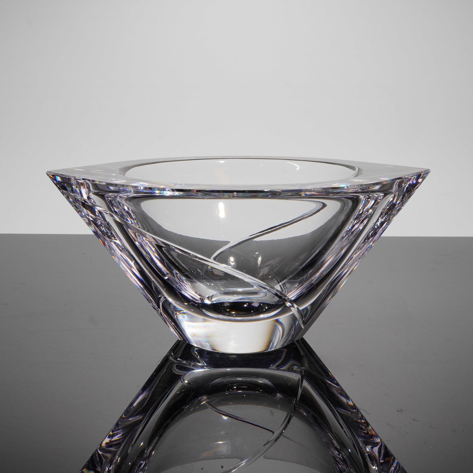 Orrefors Jan Johansson Marin Swirl Cut Crystal Bowl: A single sculptural crystal bowl designed by Jan Johansson for Orrefors, Sweden, in the Marin Swirl Cut patern. The vessel is crafted from heavy, clear crystal exhibiting thick walls and a dynamic, ta