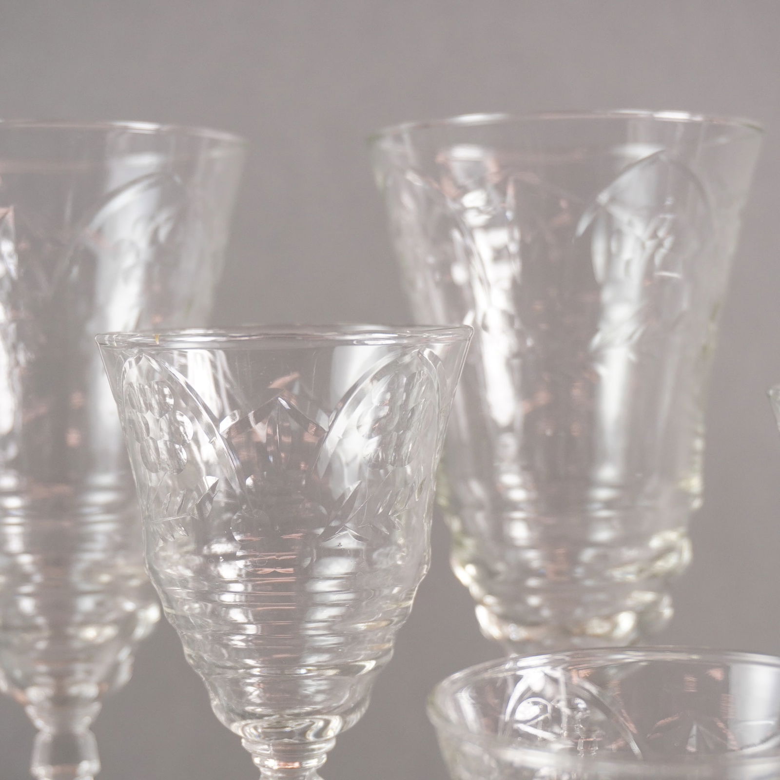 A Collection of 22 Libbey Rock Sharpe Arctic Rose Crystal Stemware: A collection of 22 pieces of vintage clear cut crystal stemware by Libbey Rock Sharpe, in the Arctic Rose pattern. This suite of glassware is constructed of clear cut glass, likely crystal, featuring