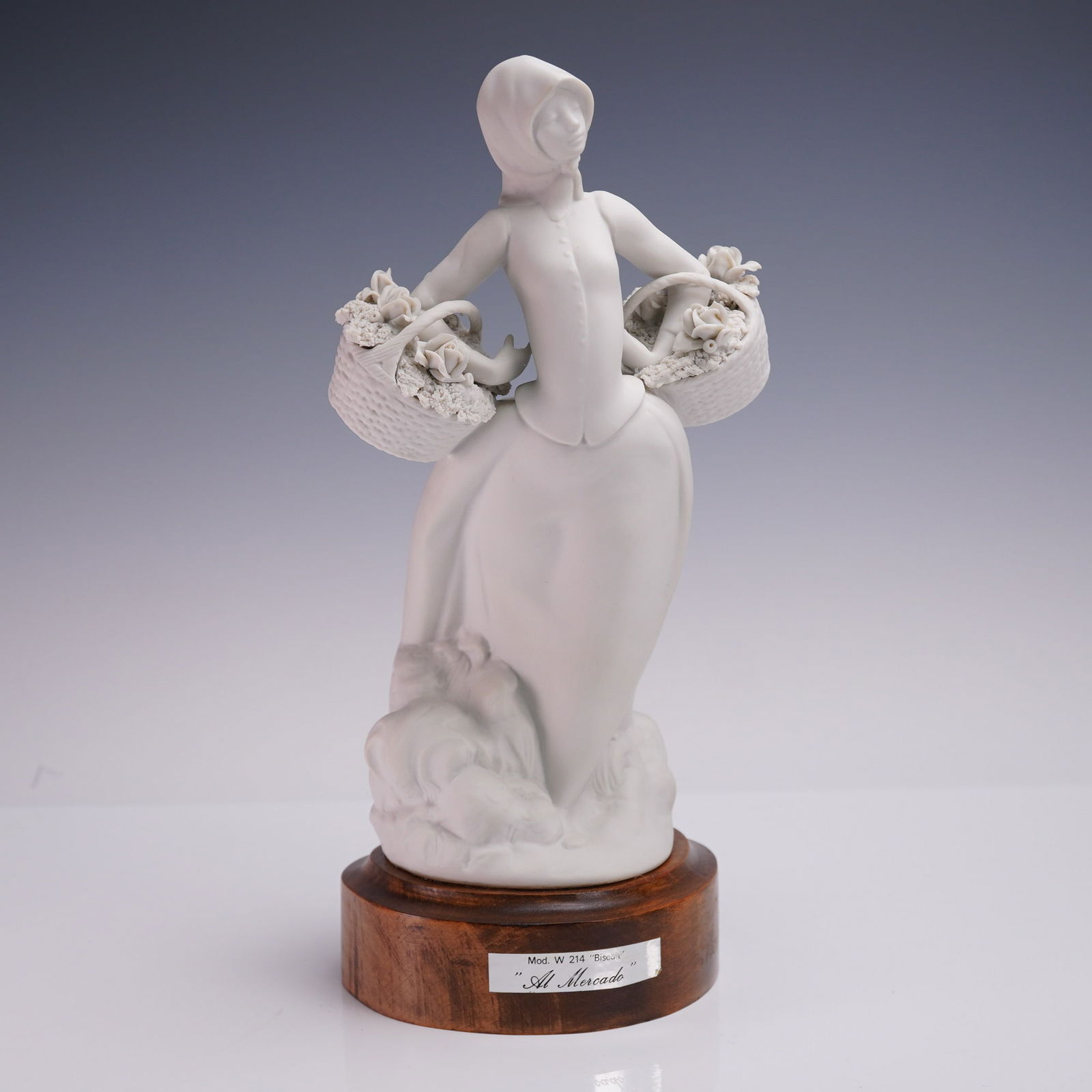 Al Mercado Bisque Porcelain Figurine with Flowers: Elegant bisque porcelain figurine titled Al Mercado, model W 214, depicting a veiled woman carrying twin baskets overflowing with delicate roses and textured floral detail. The matte white finish high