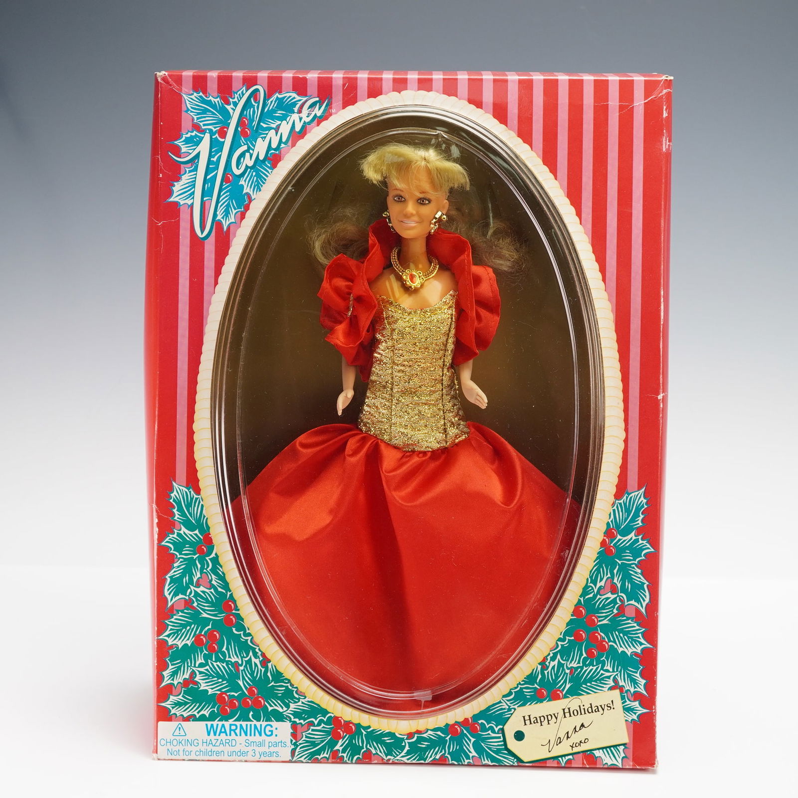 Vanna White Holiday Doll: This Vanna doll is dressed in a red satin gown with gold detailing and features a necklace and earrings. The packaging includes a Happy Holidays label making it a festive addition for collectors. Rele