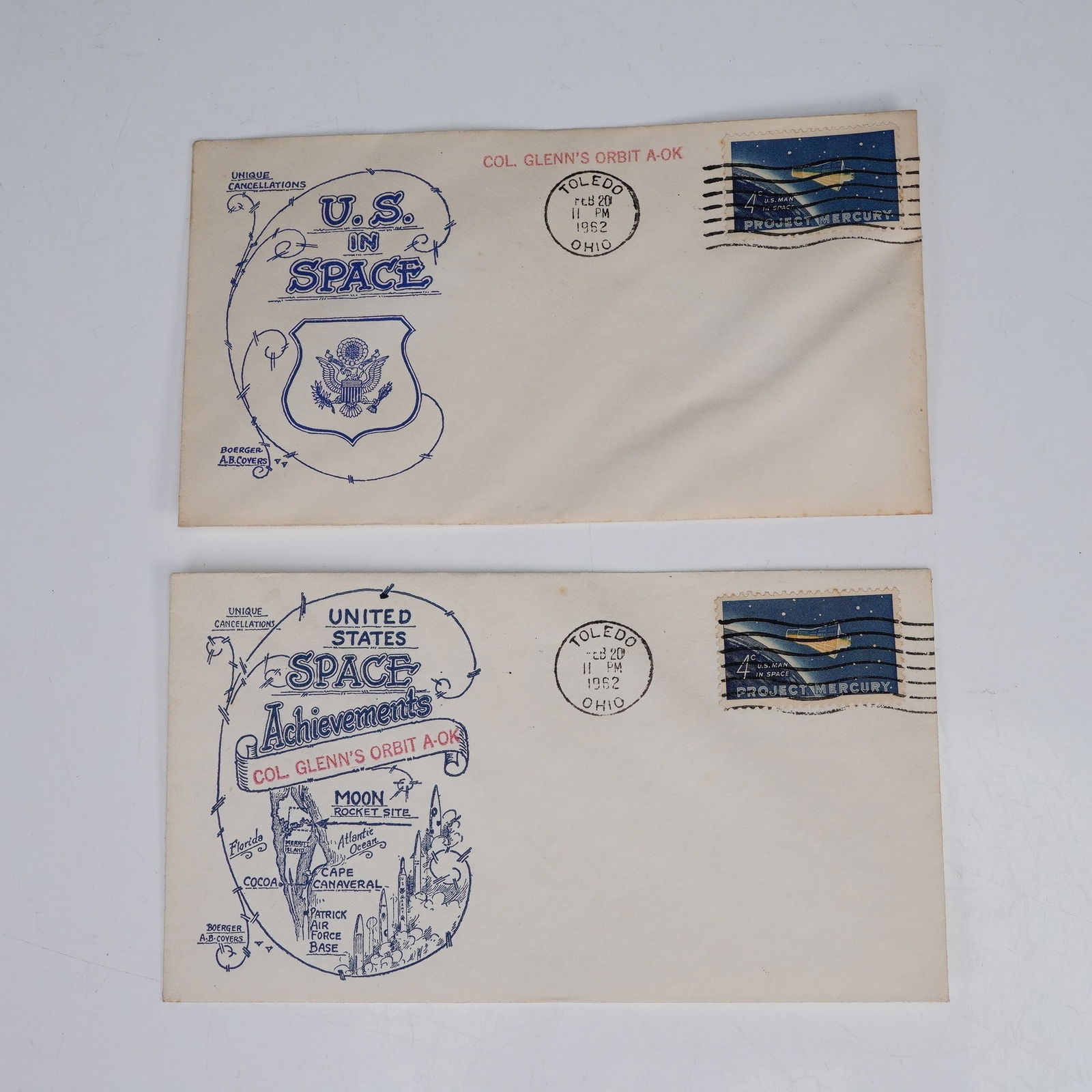 2pc 1962 U.S. Space Achievements Stamped Envelopes, Col Glenn's Orbit A-OK: Commemorative envelopes featuring U.S. space program themes, both with printed cachets by Alfred Boerger Covers of Toledo, Ohio. Each envelope bears a 4-cents Project Mercury postage stamp and cancell