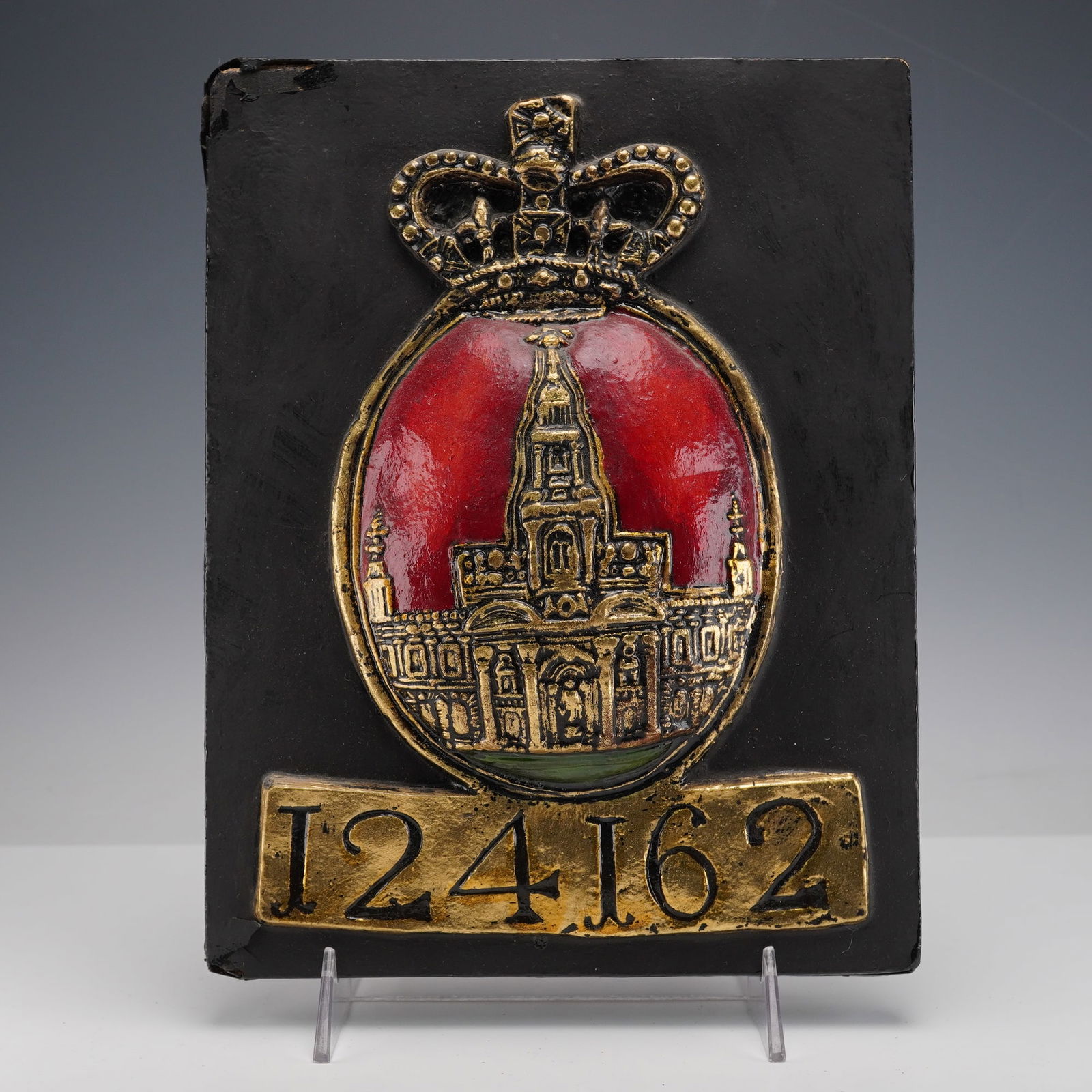 Royal Exchange Assurance by E. V. Jackson Reproduction Fire Mark Plaque: A molded reproduction fire mark plaque by E V Jackson depicting the second Royal Exchange building in London, shown within an oval field of red enamel beneath a crowned crest, with raised gilt details