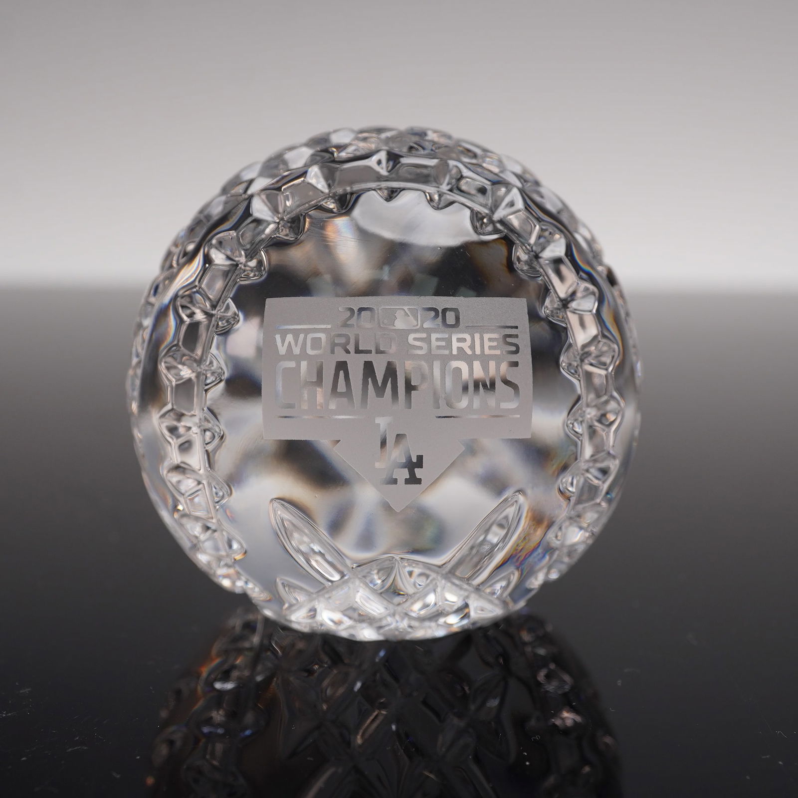 Waterford Crystal 2020 World Series Champions Baseball Paperweight: Celebrating the Los Angeles Dodgers as the 2020 World Series Champions. Expertly crafted in the shape of a baseball, this limited edition paperweight features intricate cut crystal detailing and an et