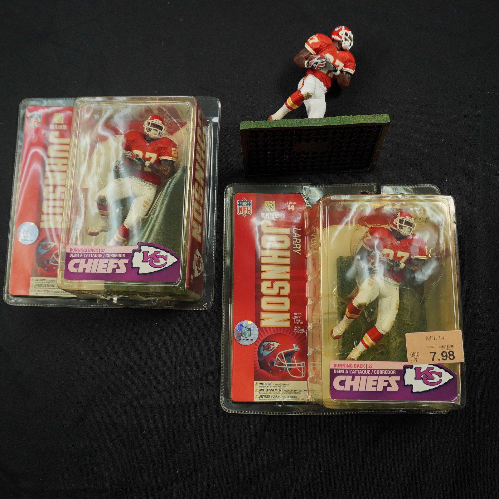 3pc Larry Johnson Kansas City Chiefs Figurines: Group of three collectible NFL figurines featuring Kansas City Chiefs running back Larry Johnson (#27). Includes two factory-sealed articulated McFarlane Toys action figures from the NFL Series 14 lin