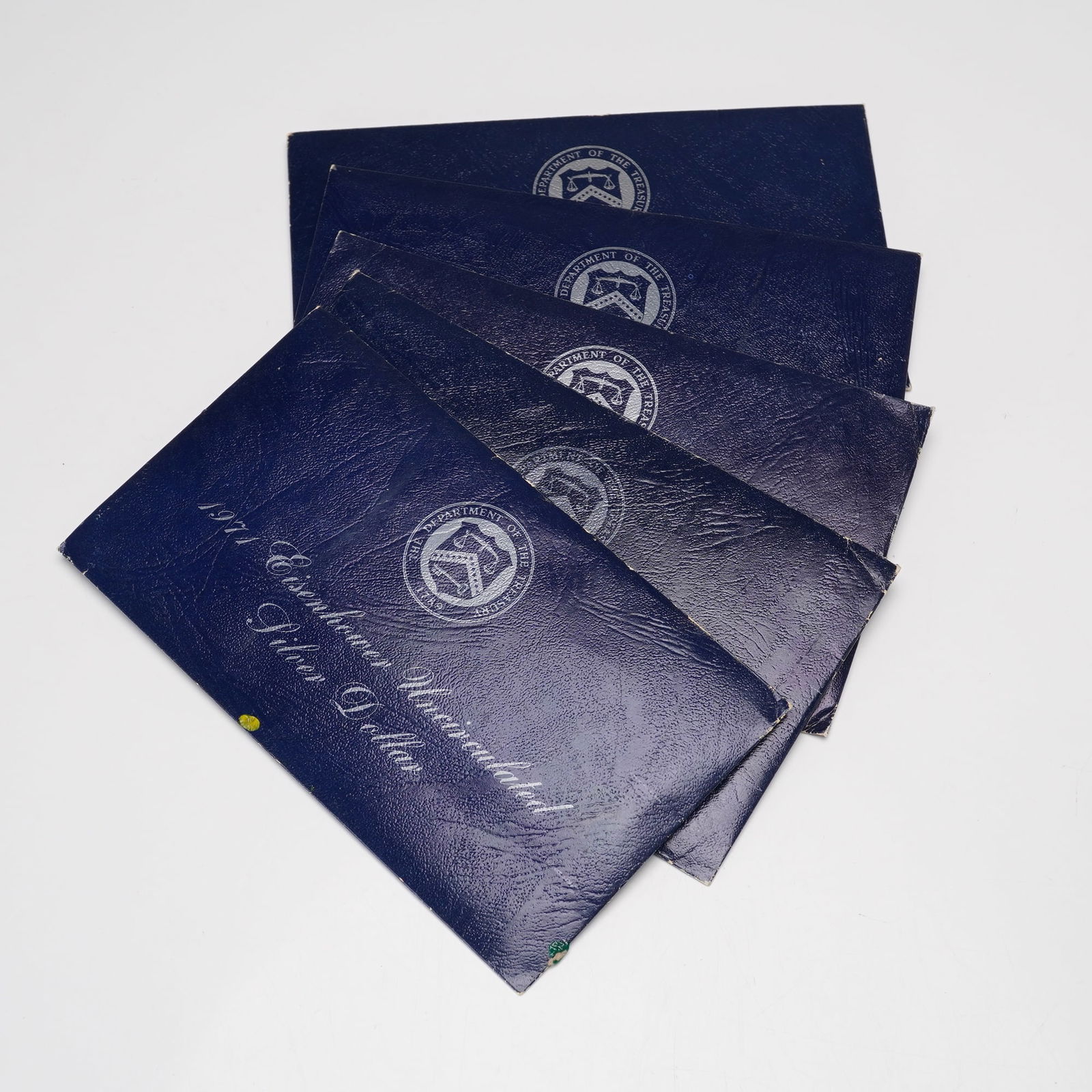 5pc 1971-S Eisenhower Uncirculated Silver Dollar Coins: This lot includes five 1971 Eisenhower Silver Dollar coins minted at the San Francisco Mint, each housed in its original blue government packaging. The set also includes five collection medallions. Th