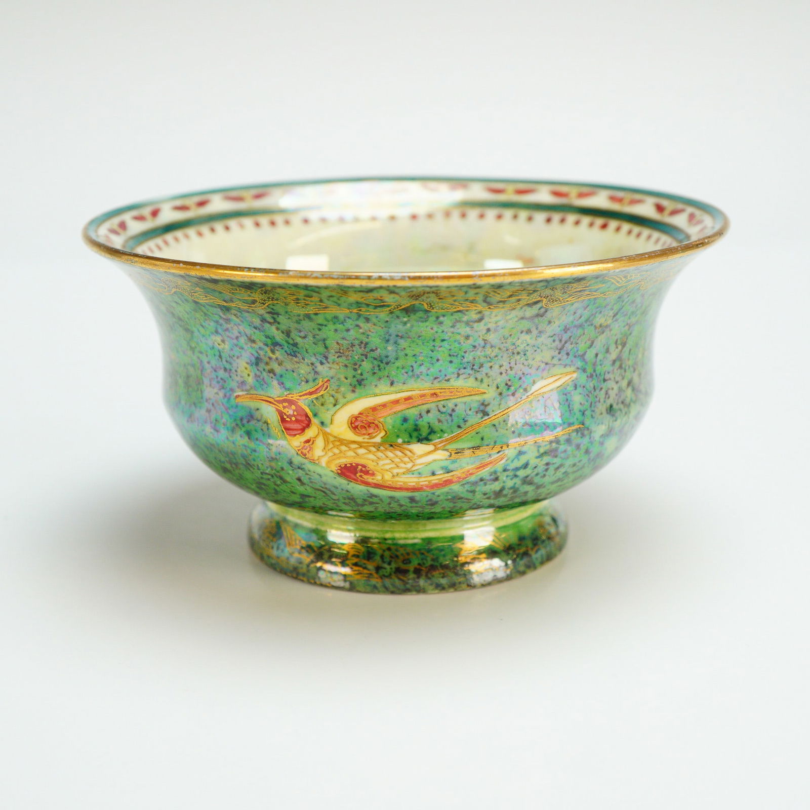 Wedgwood Fairyland Lustre Bowl, Flying Humming Birds Z5088: Designed by Daisy Makeig-Jones (British, 1881-1945). The exterior is finished in dark green lustre with blue mottling and decorated with flying hummingbirds in red, white, yellow, and gilt, with "Flyi
