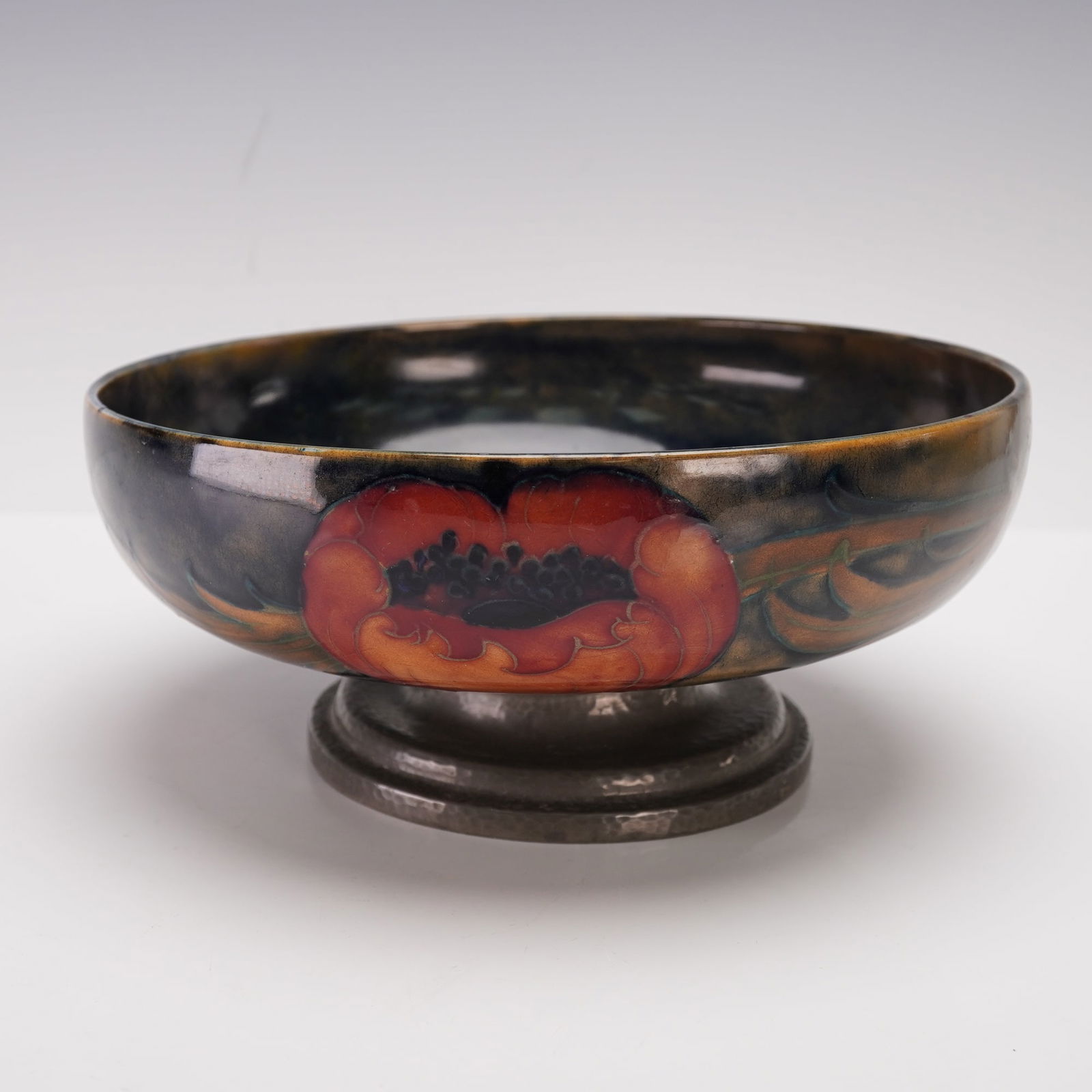 William Moorcroft Liberty & Co. Tudric Pewter Pottery Bowl , Big Poppies: Exquisite pedestal pottery bowl mounted on an original Tudric pewter base. The exterior and interior are tube lined decorated with vivid poppies accented by deep indigo and moss-green foliage, Tudric
