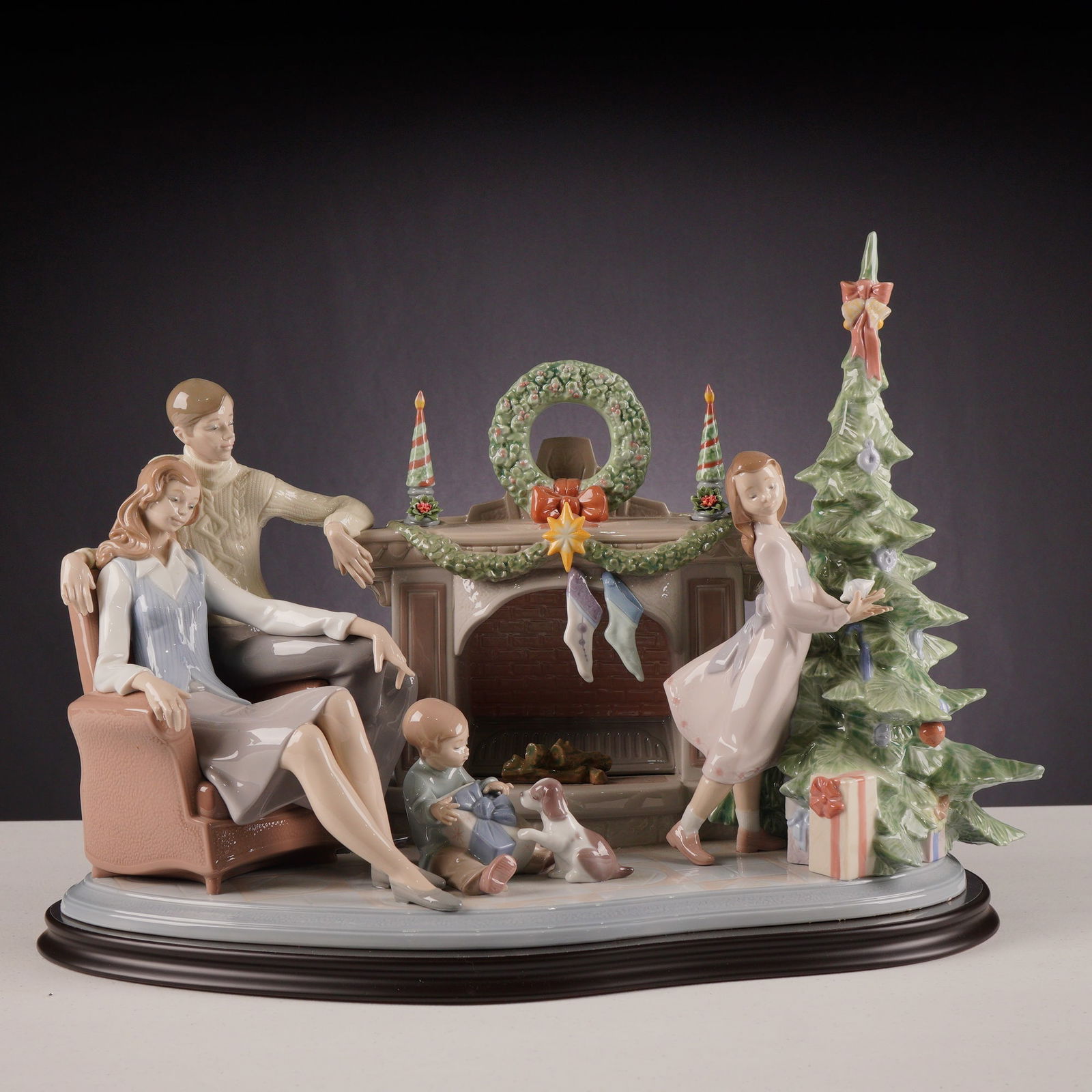 Lladro Porcelain Sculpture A Family Christmas 01008260 with Base: A large Lladro porcelain sculpture group titled A Family Christmas, reference number 01008260. This retired limited-edition piece is numbered 262 out of 750 produced. The sculpture depicts a complex h