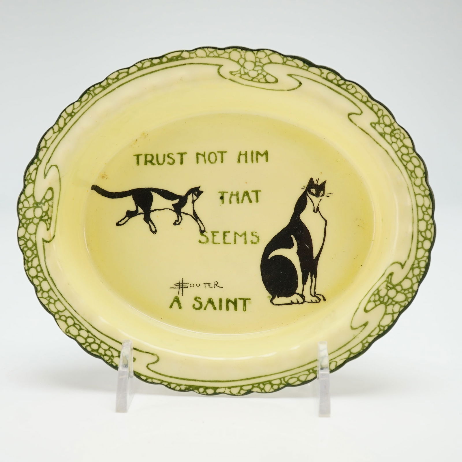 Royal Doulton by Henry Souter Series Ware Bowl, Kateroo: The composition displays two stylized feline figures in varied orientations, separated by the inscribed cautionary adage "Trust Not Him That Seems A Saint." The vessel bears the signature of the artis