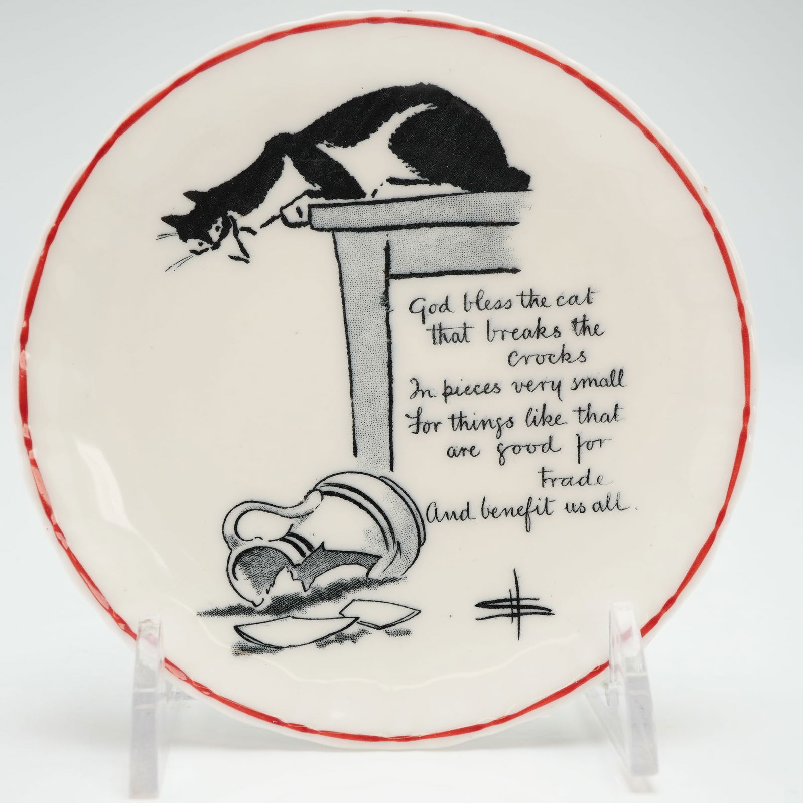 Royal Doulton Round Cat Pin Dish, Souter Kateroo: This dish features a graphic illustration by artist David Henry Souter depicting a black and white cat positioned atop a table while observing a fractured ceramic jug on the floor. The composition inc