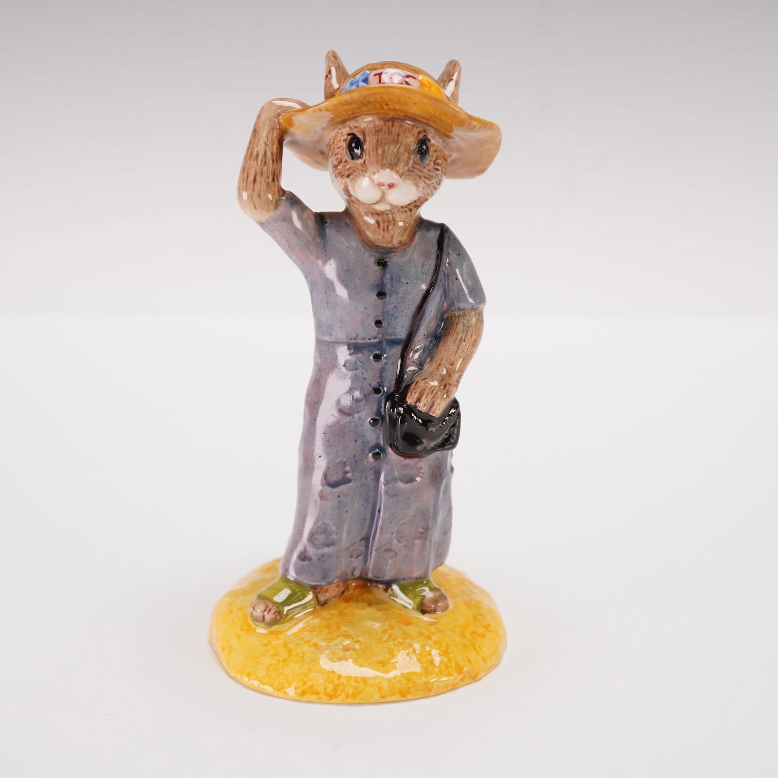 Royal Doulton Bunnykins Prototype Design Figurine, Sightseer: This Royal Doulton Bunnykins prototype figurine, titled Sightseer DB215, is a Design Original Sample featuring a rabbit figure in a gray dress and orange wide-brimmed hat. The figure is posed with one