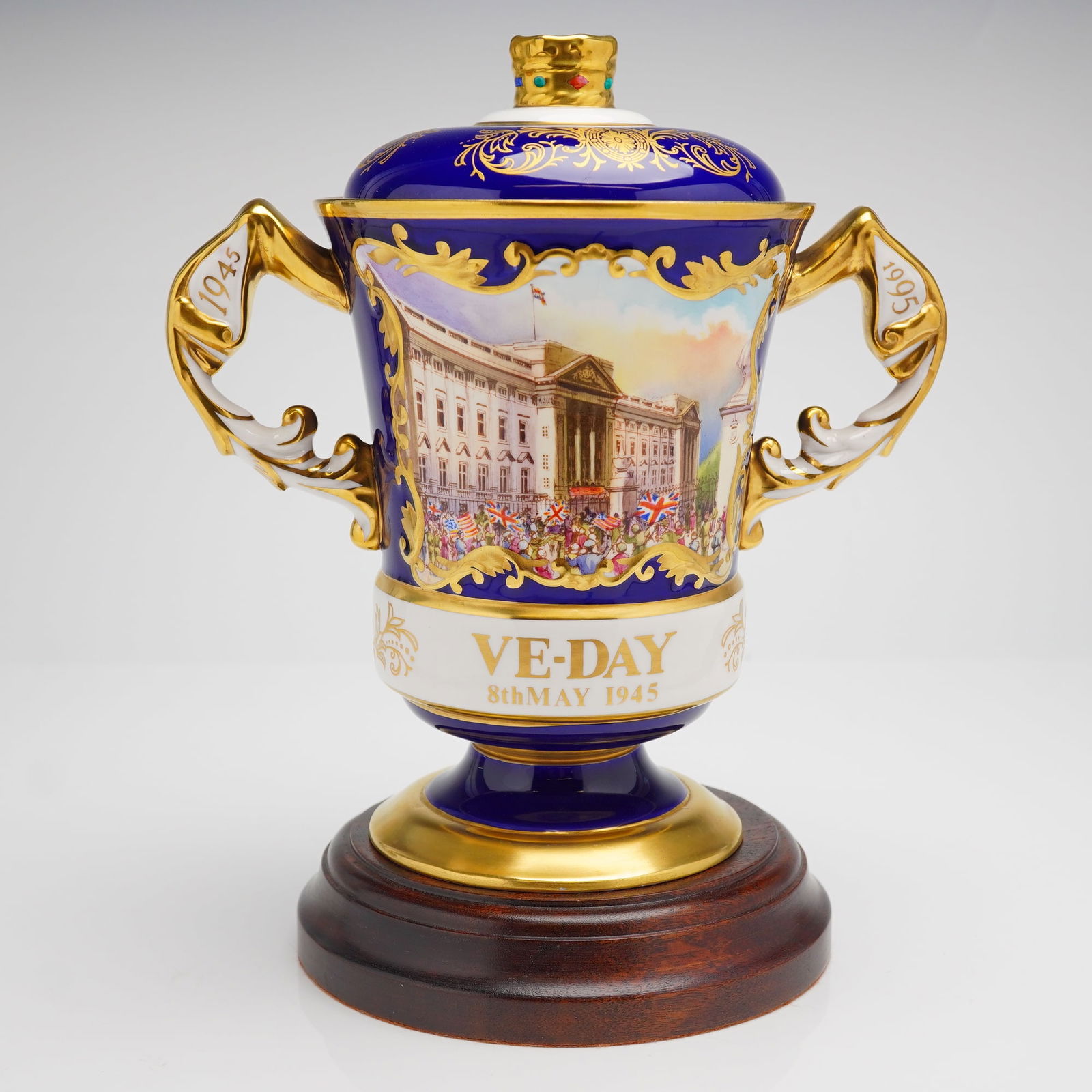 Aynsley Bone China V.E.-Day 50th Anniversary Commemorative Urn with Base: A limited edition Aynsley bone china Celebration vase, commemorating the 50th Anniversary of V.E.-Day (Victory in Europe), 1945-1995. The urn is executed in deep cobalt blue and white panels, heavily
