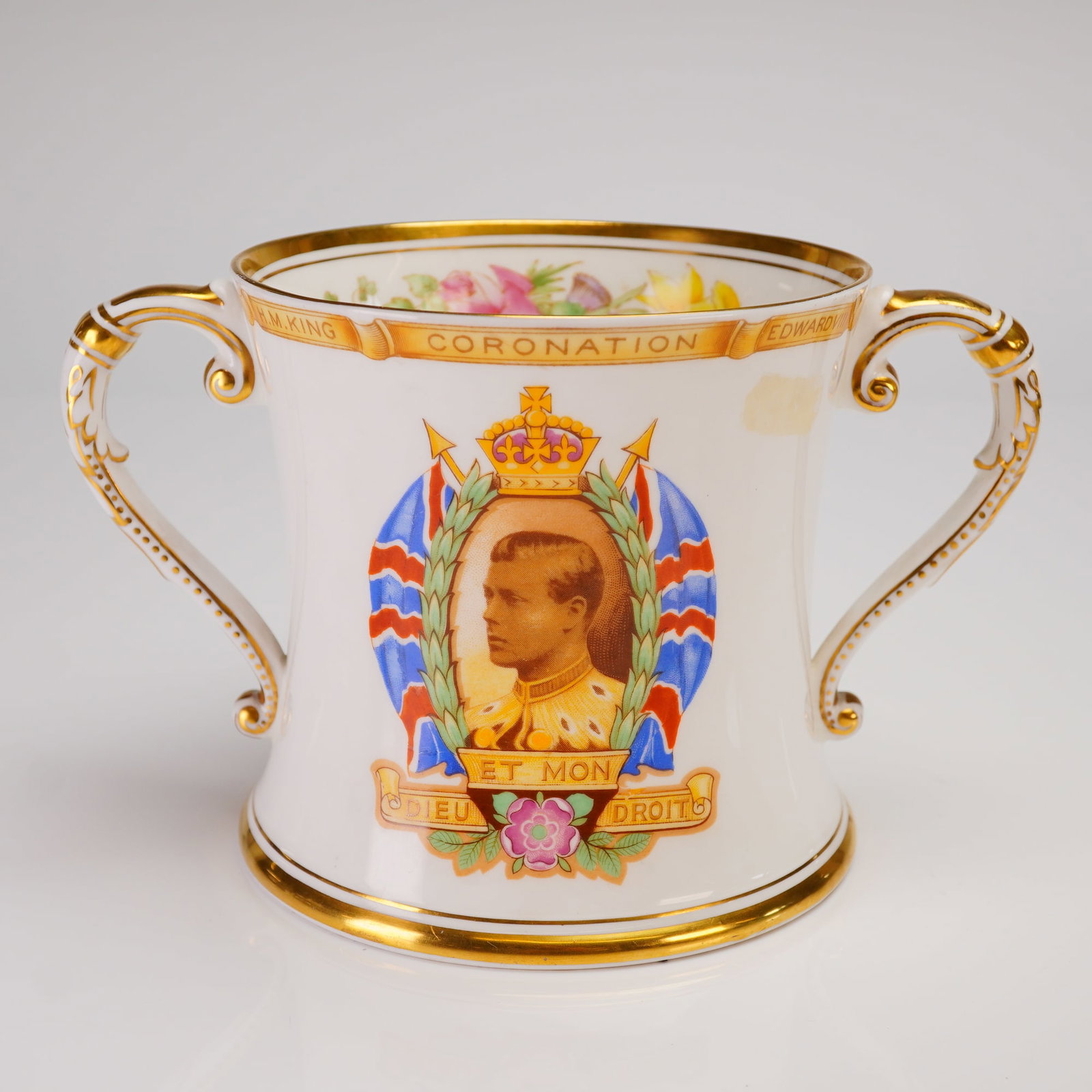 Shelley England Porcelain King Edward VIII Coronation Loving Cup: A single Shelley England porcelain two-handled loving cup, produced as commemorative ware for the planned Coronation of King Edward VIII in 1937. The white porcelain body is heavily accented with exte