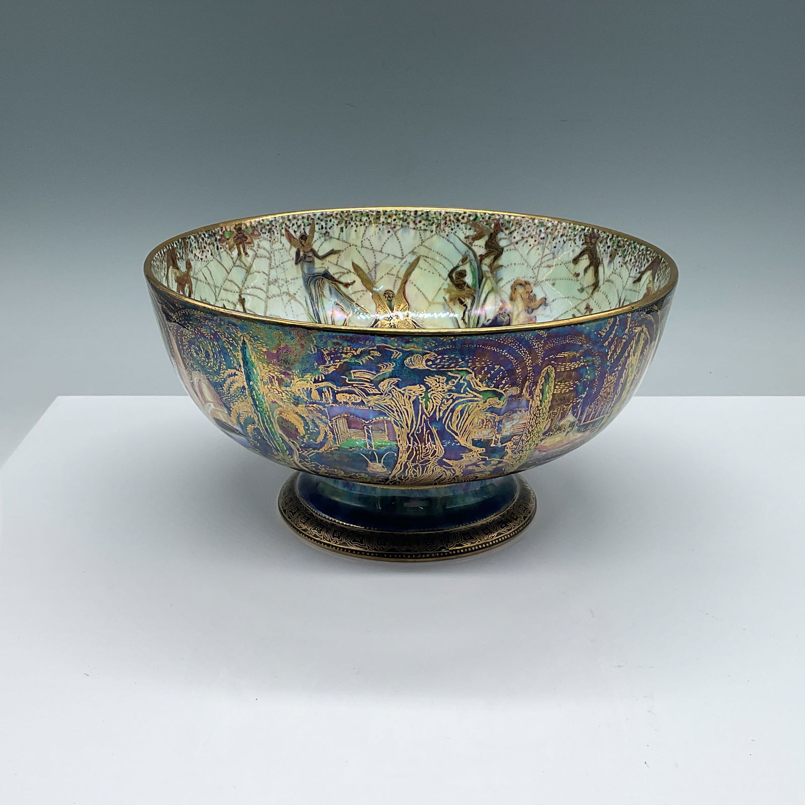 Wedgwood Fairyland Lustre Bowl: This exquisite Wedgwood Fairyland Lustre bowl, designed by Daisy Makeig-Jones, showcases her signature ethereal artistry. Measuring 4.25"H x 9" in diameter, it features vibrant iridescent glazes, intr